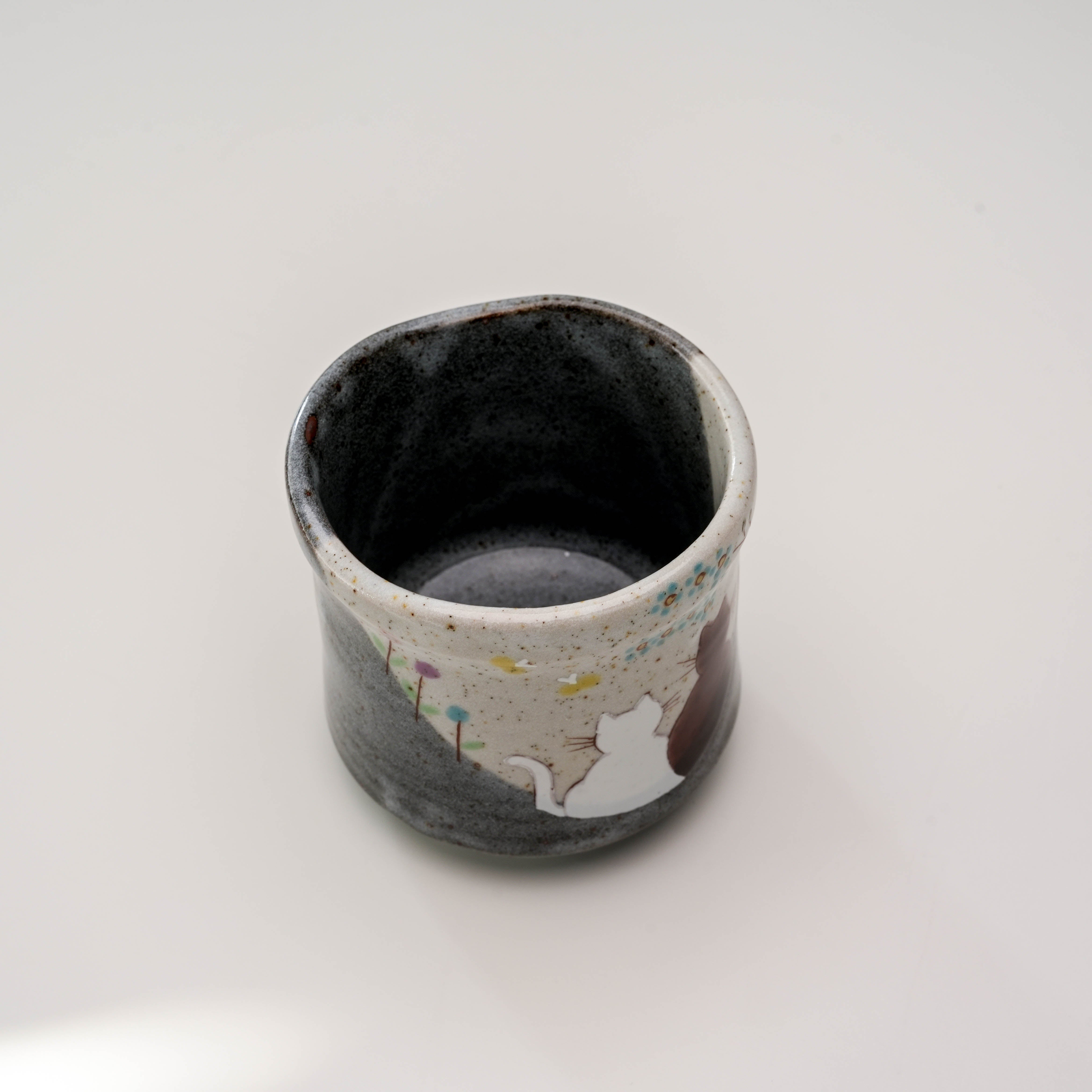 Top view of Kutani Cat Yunomi Teacup revealing its smooth interior and unique rim shape. Perfect for enhancing tea rituals with artistic flair.