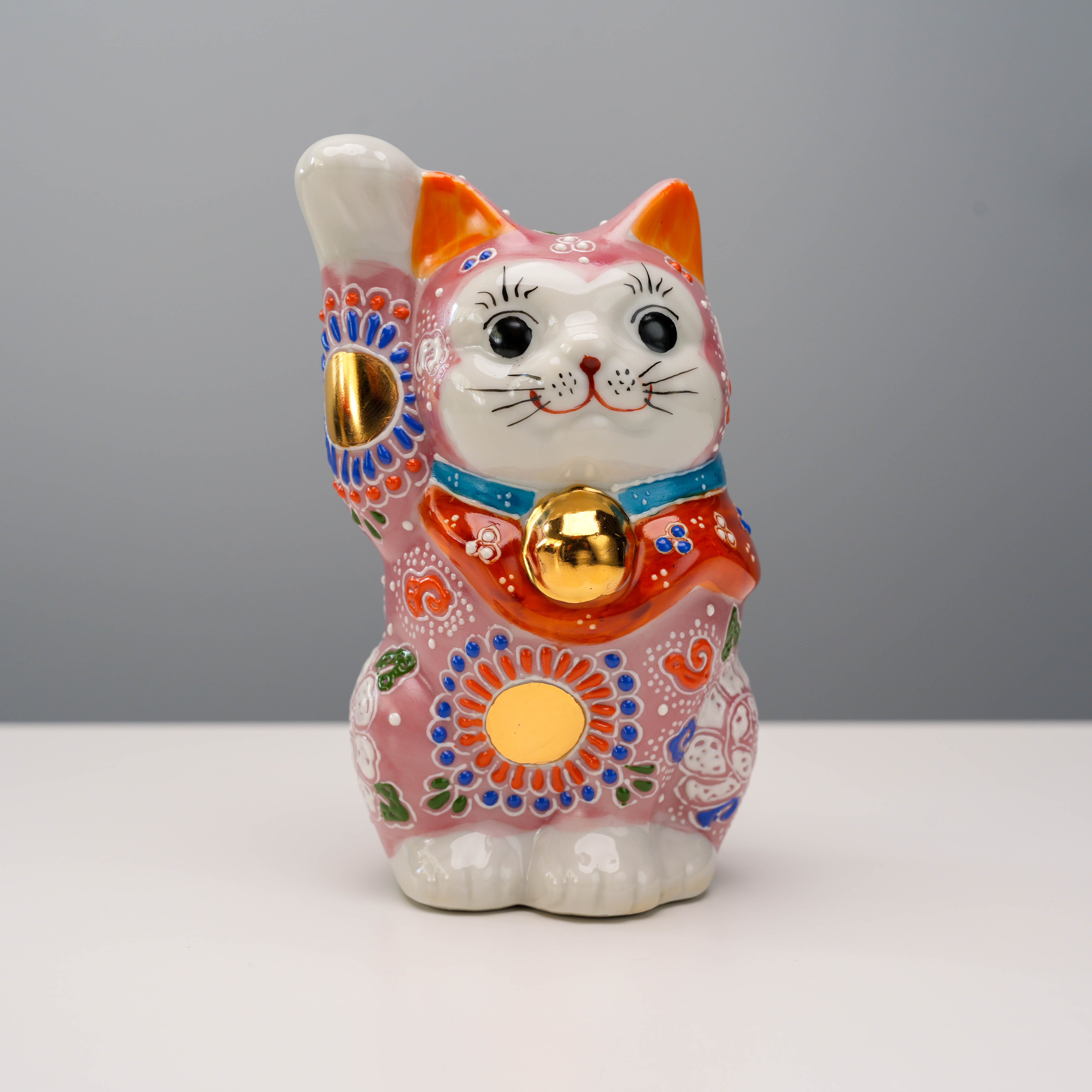 Front view of Kutani Ware Cat Ornament - Lucky Cat featuring detailed pink floral design, golden bell, and traditional Japanese craftsmanship.