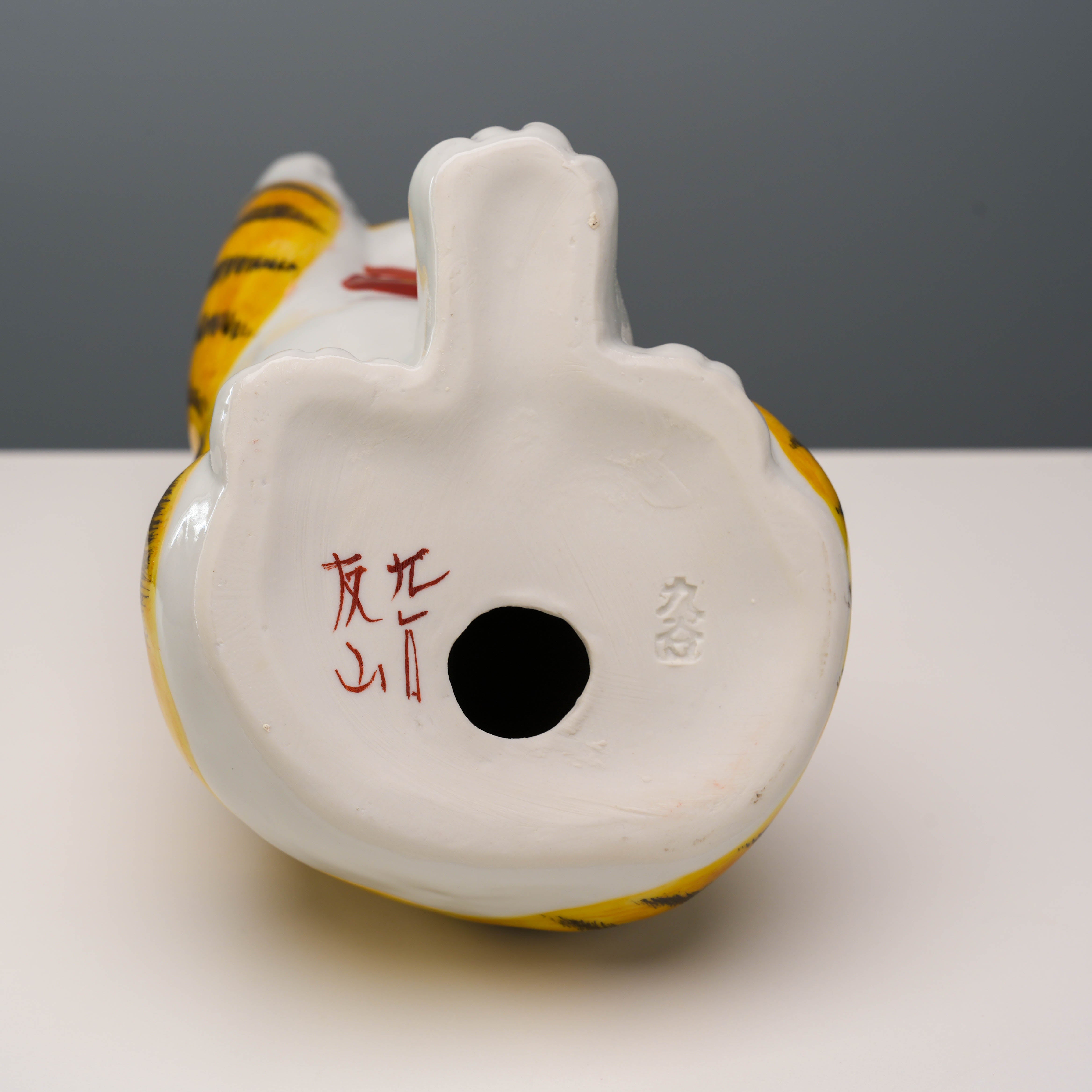 Bottom view of Kutani Ware Cat Ornament showing artist's signature and hollow base, authenticating its handcrafted origin.