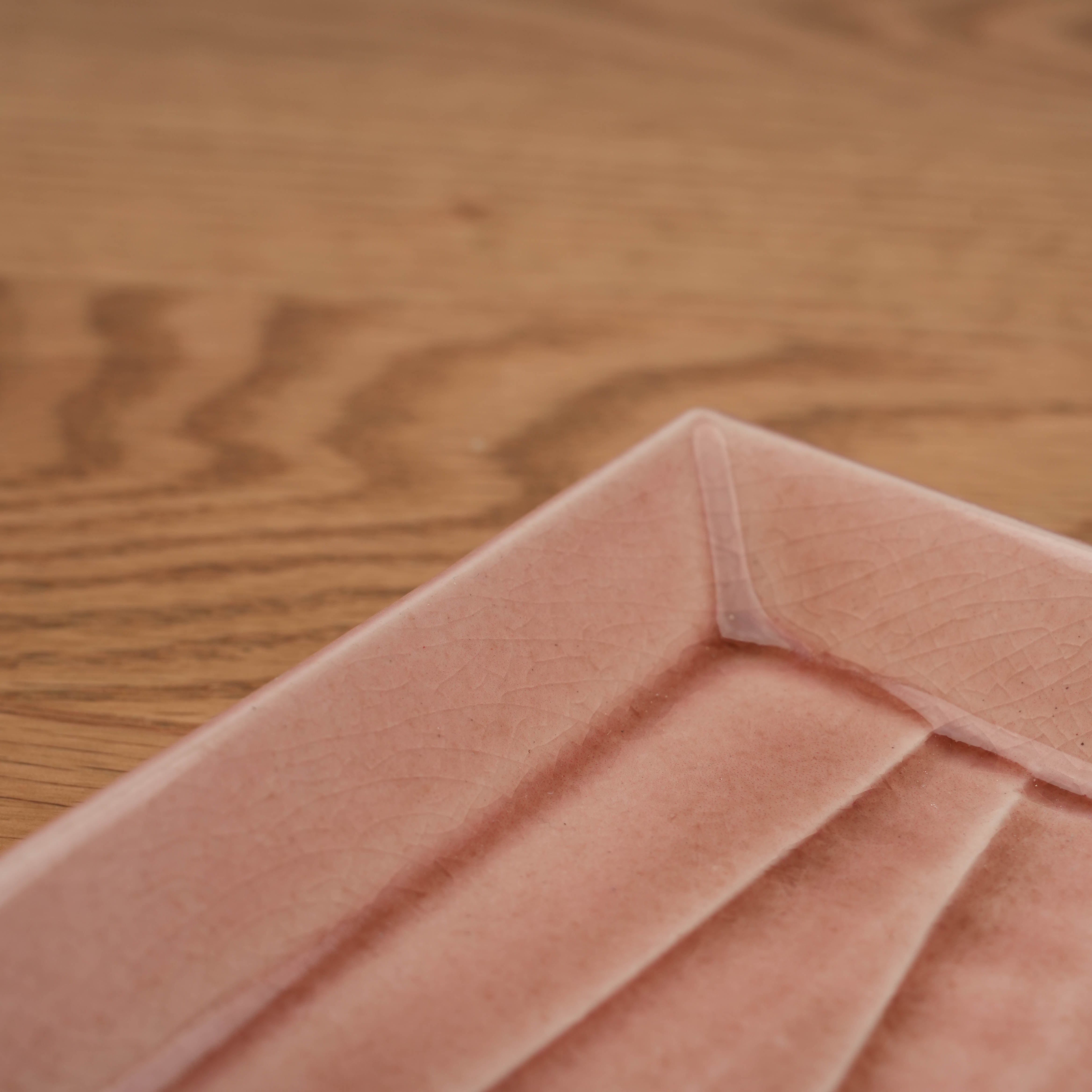 Close-up of the Mino Ware Rose Pink Square Plate highlighting the intricate crackle glaze texture. Adds artisanal charm to any tableware collection.