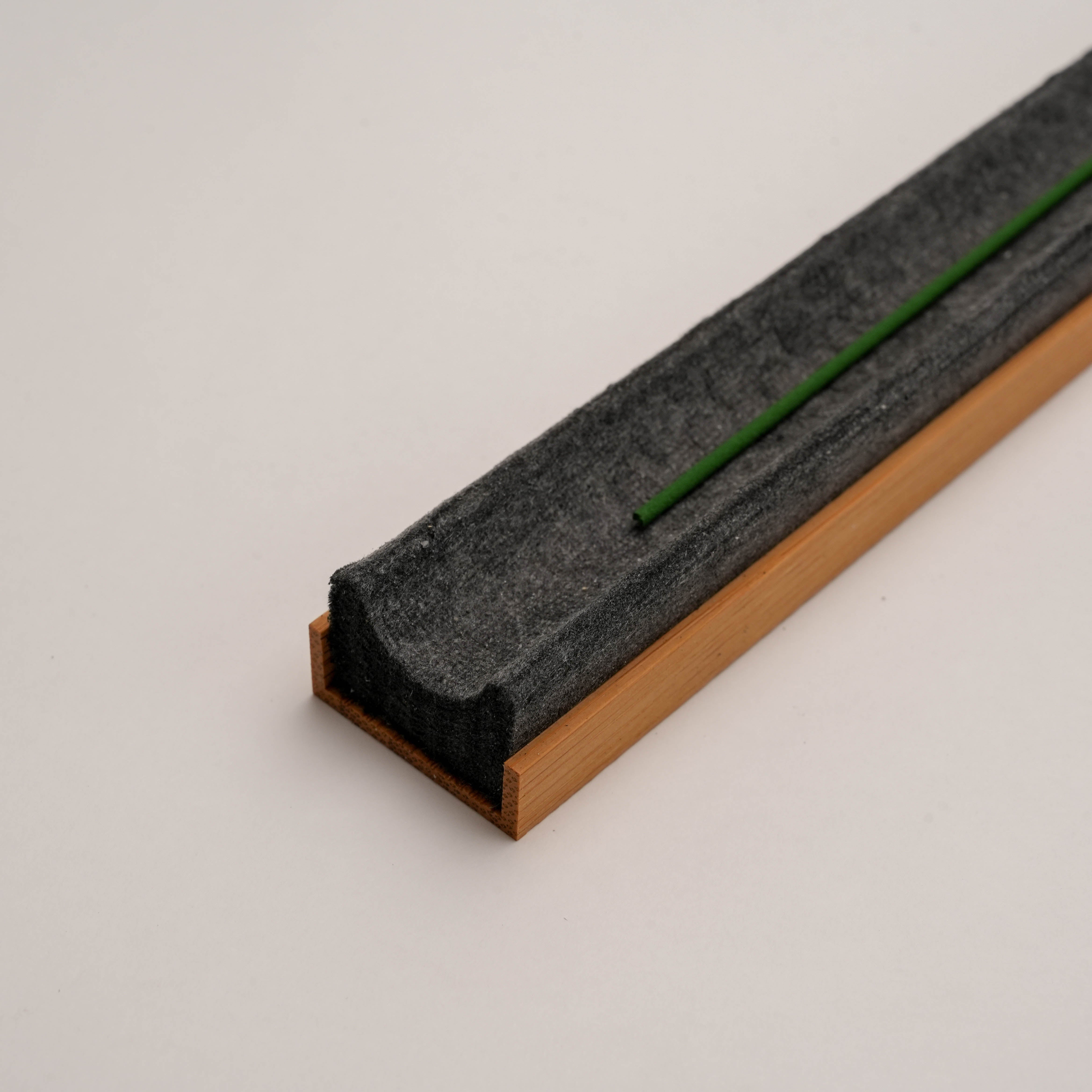 Shoyeido Incense Tray - Takuba in use with green incense stick, blending function and style for modern home fragrance setups.