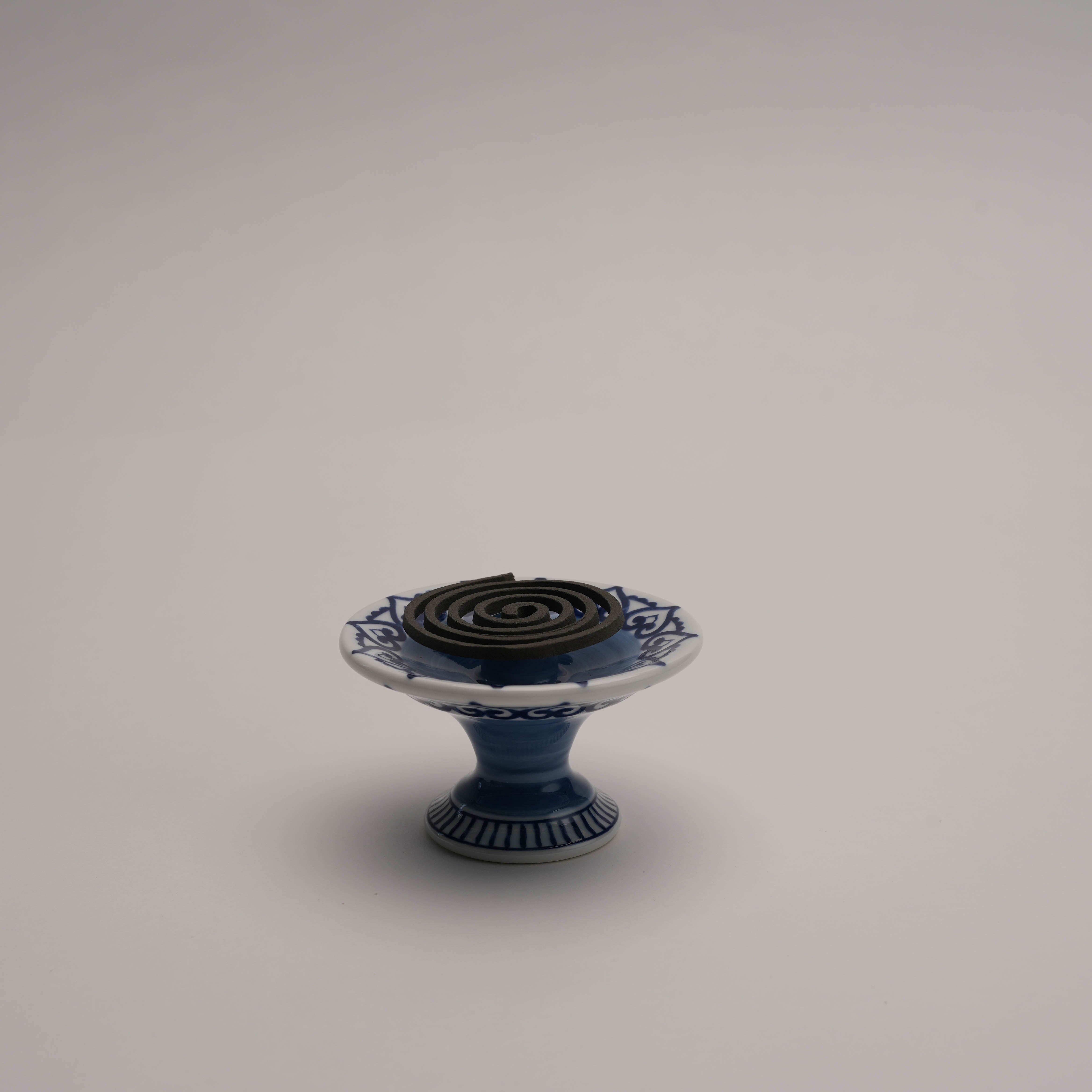 Arabesque Incense Burner - Versatile Use | Blue Design displayed with a coil incense, highlighting its multifunctional incense holder capability.