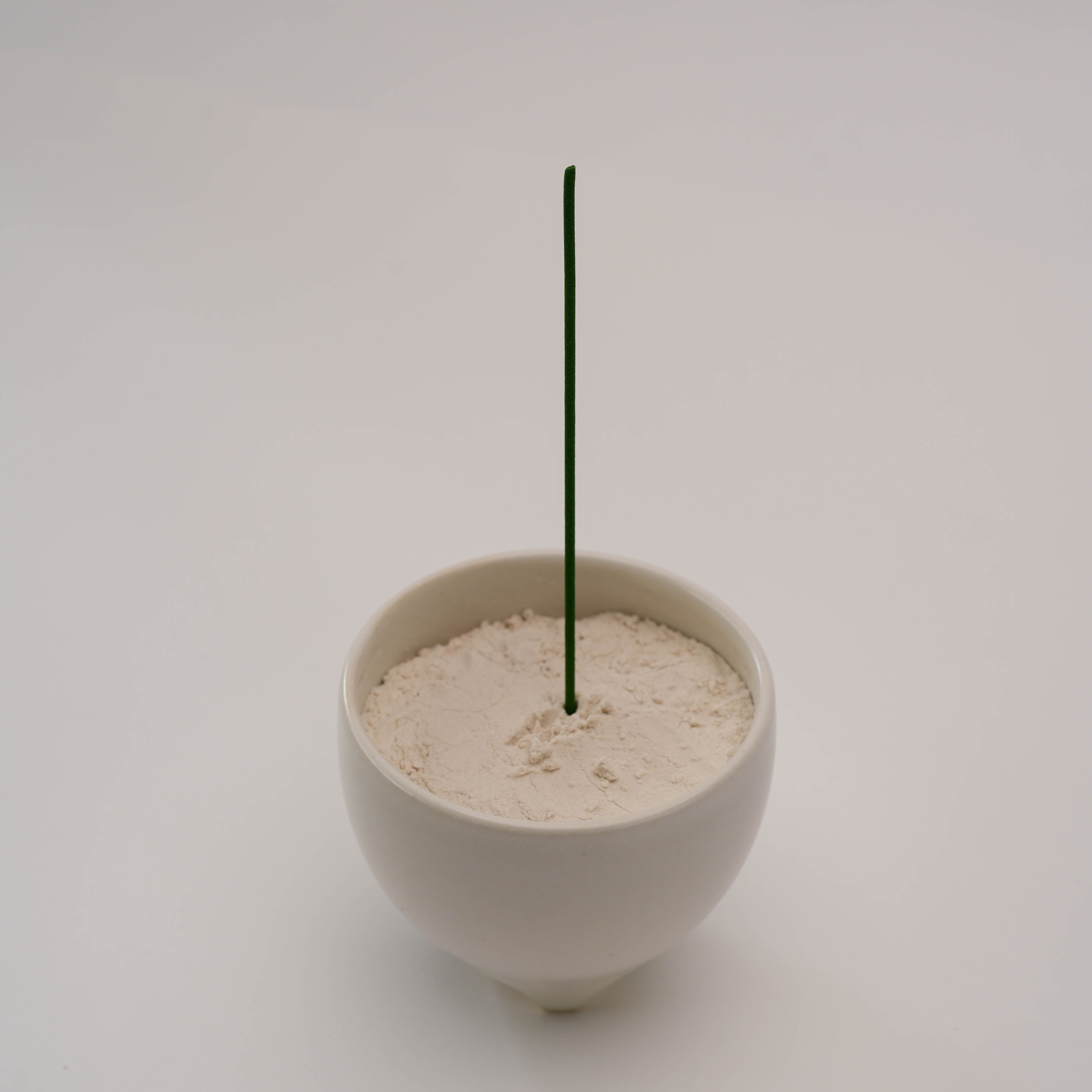 Shoyeido Incense Censer - Shiro holding a vertical incense stick in white ash, perfect for elegant incense burning at home.