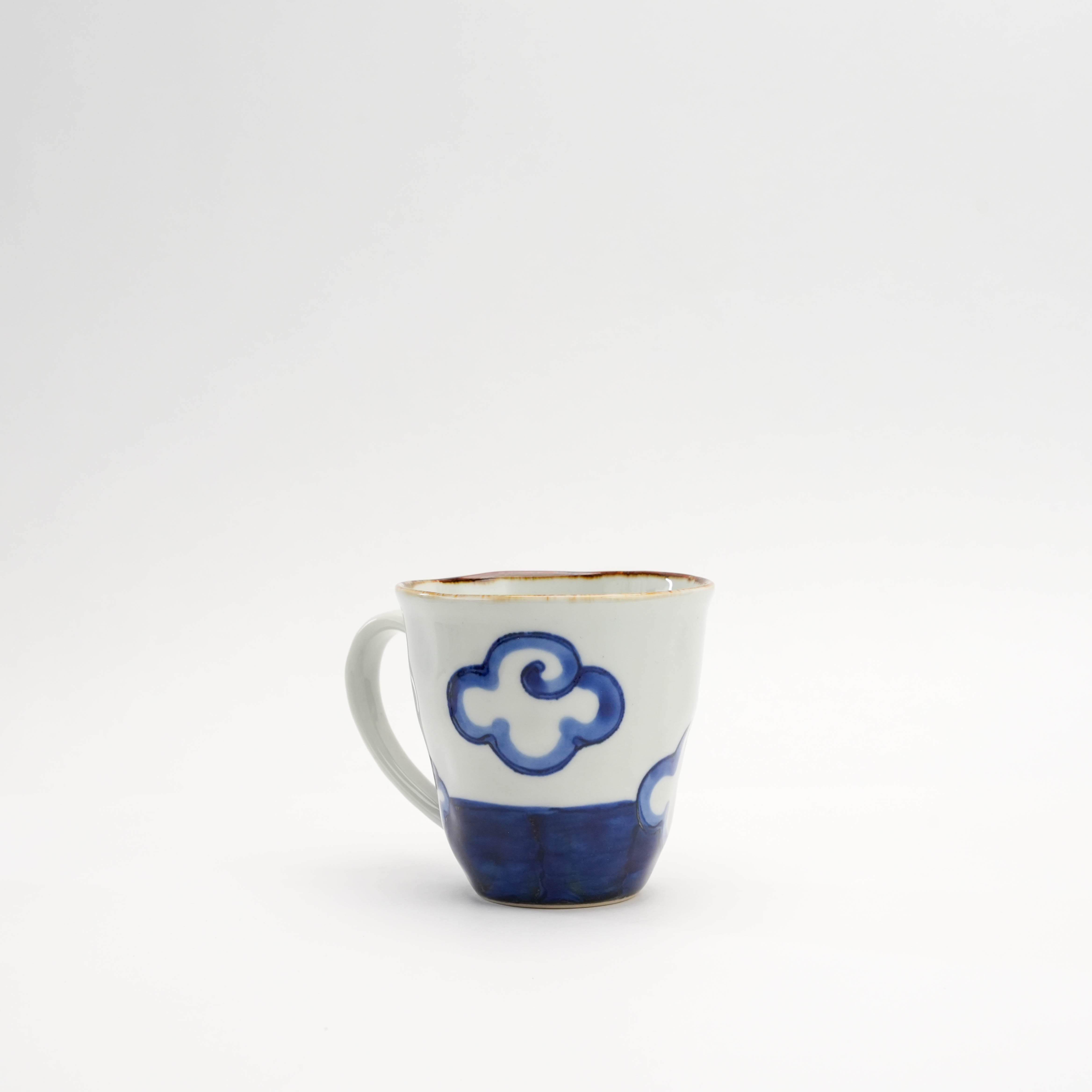 Back view of blue Arita Ware Mt Fuji Mug highlighting cloud motif. Hand-painted ceramic mug for stylish kitchen and dining.