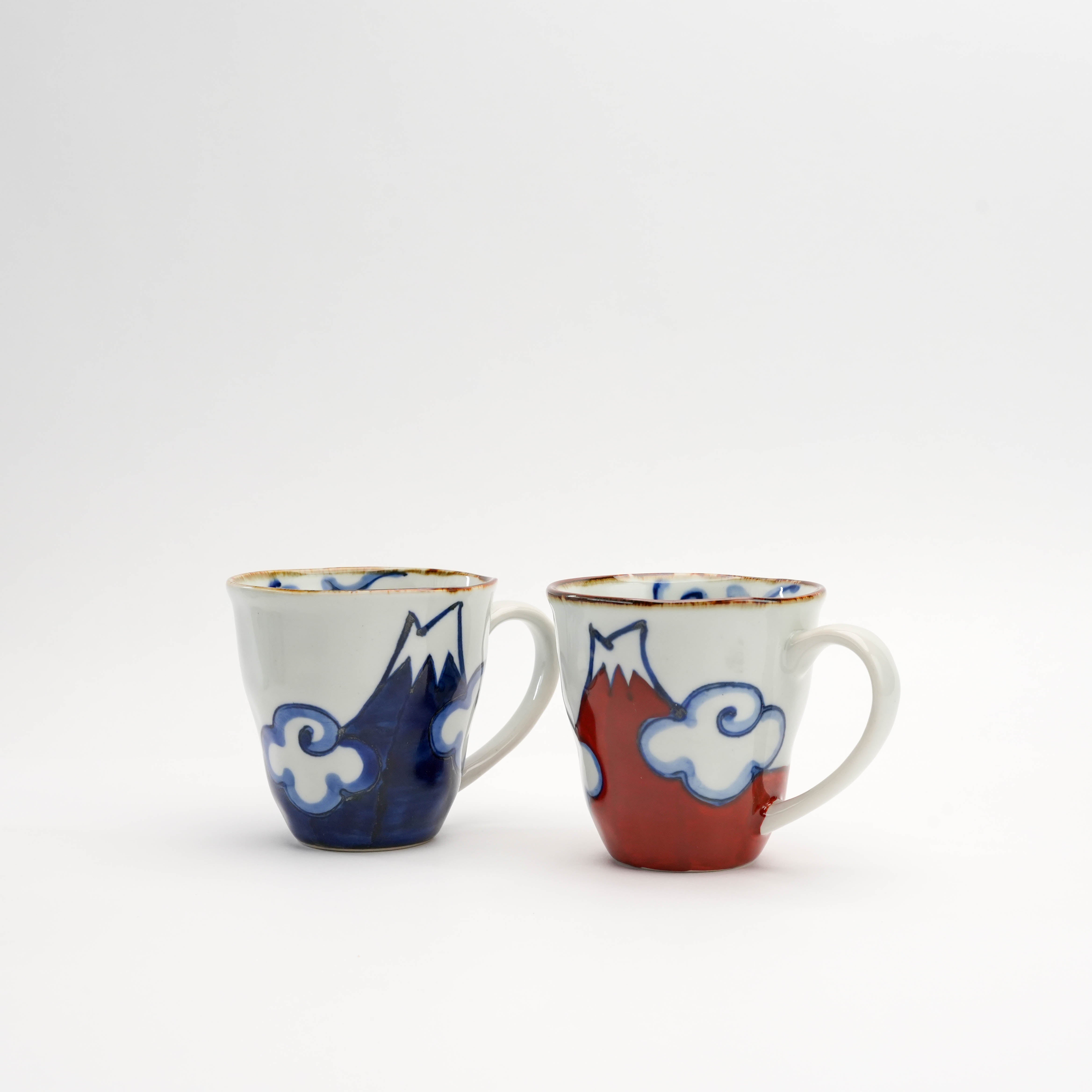 Arita Ware Mt Fuji Mug set in red and blue, hand-painted with cloud and mountain motifs. Traditional Japanese drinkware for tea or coffee lovers.