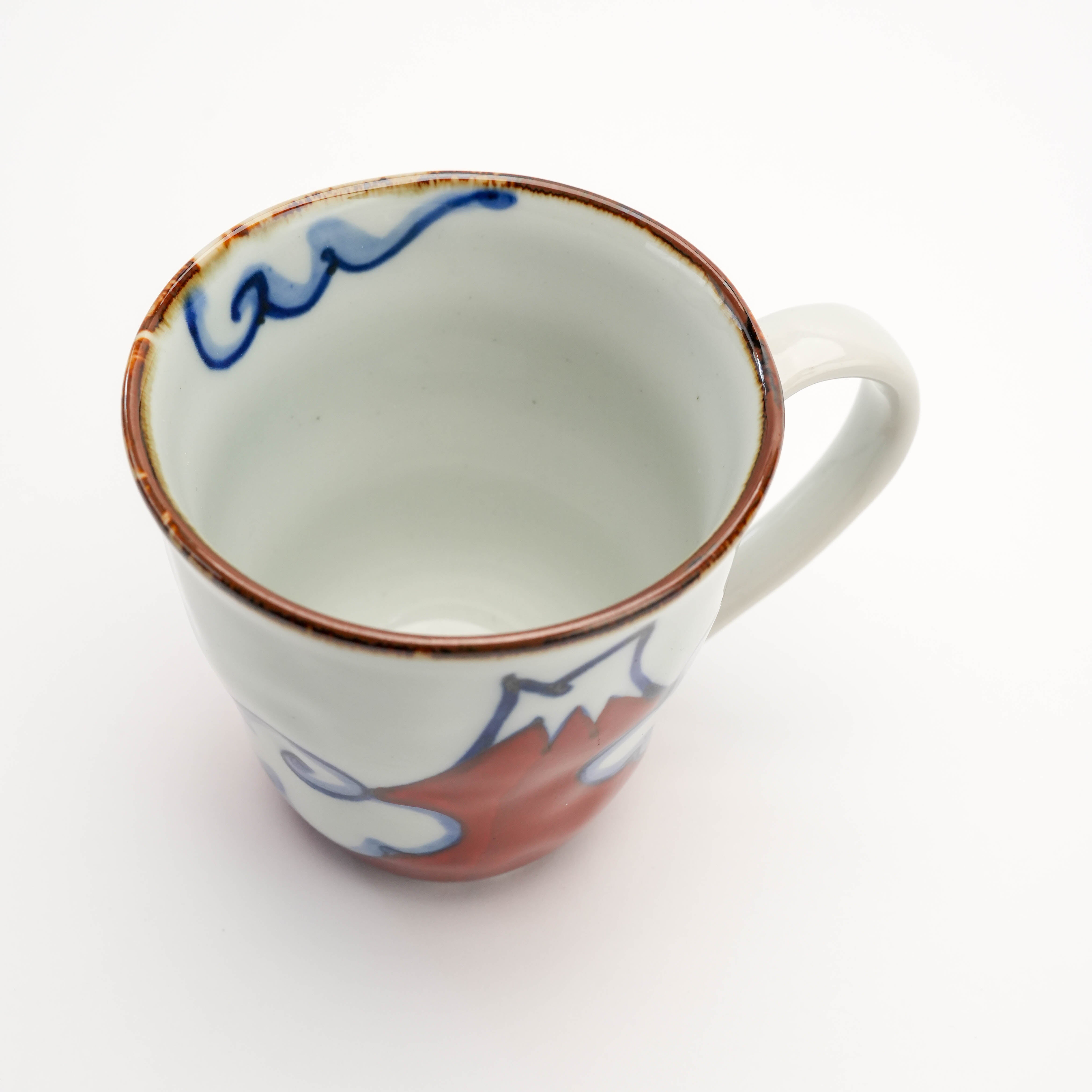 Top view of red Arita Ware Mt Fuji Mug showing interior glaze and rim detail. Hand-painted Japanese ceramic perfect for daily use.