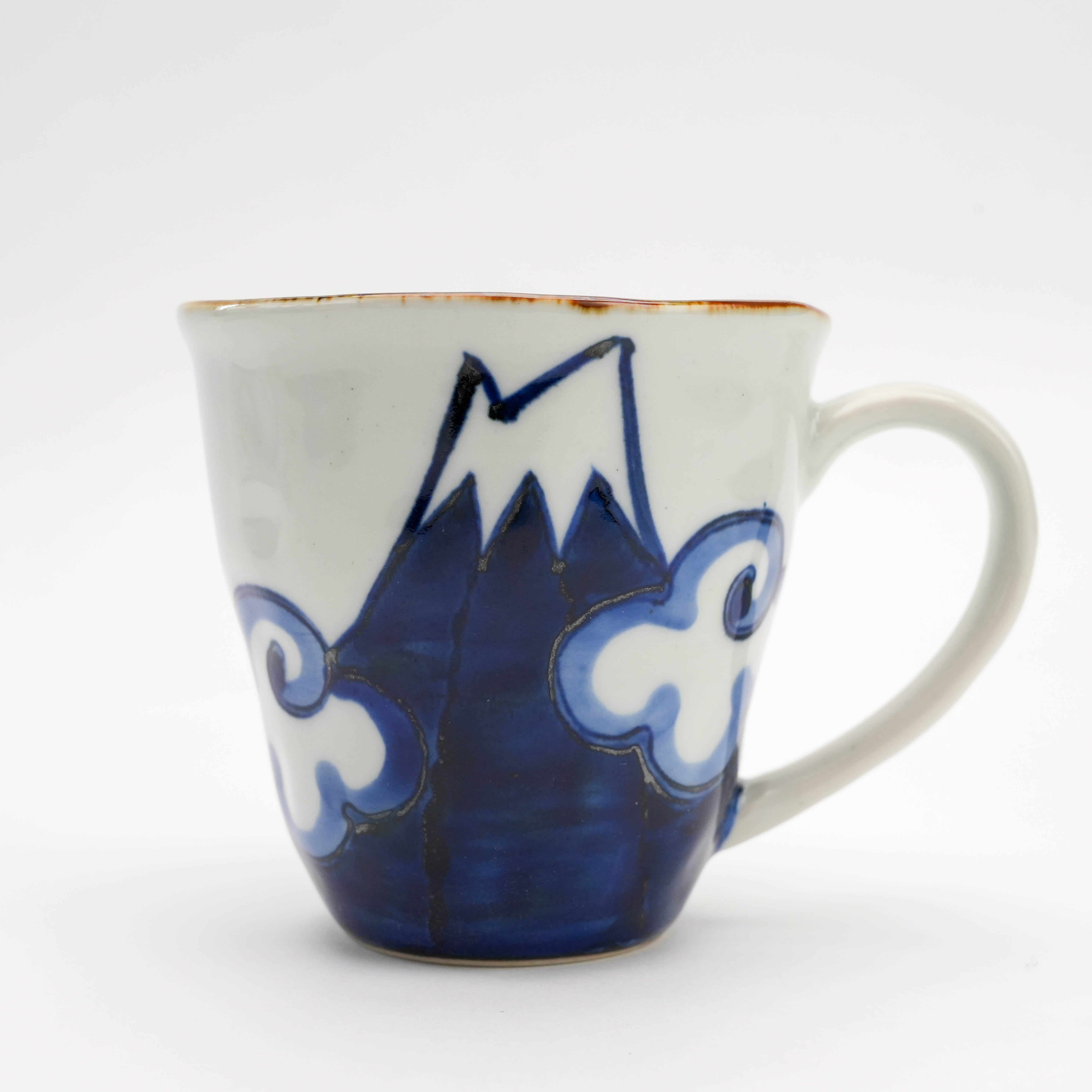 Close-up of blue Arita Ware Mt Fuji Mug showcasing Mt. Fuji and cloud artwork. Japanese ceramic mug for tea or coffee enthusiasts.