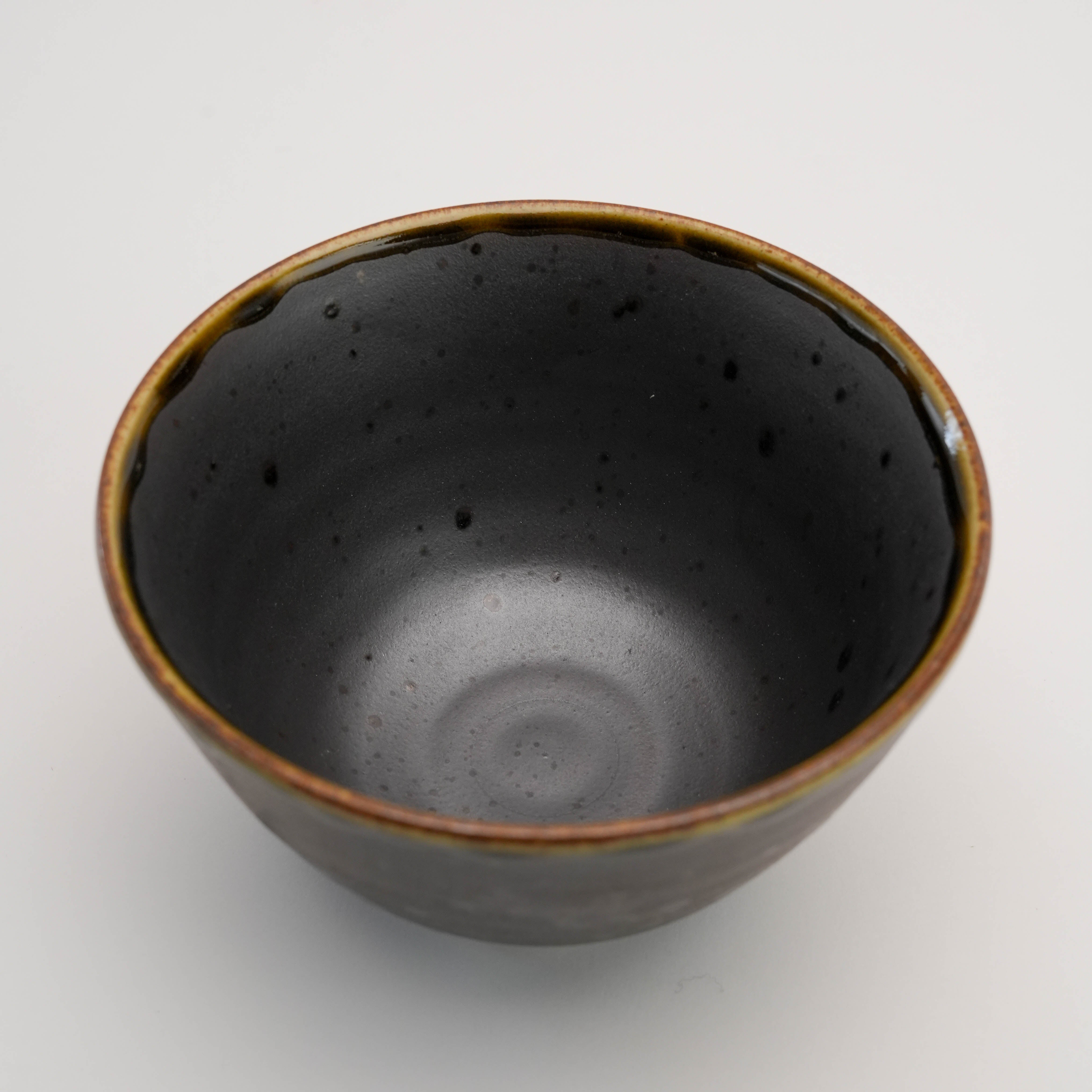Top view of Arita Ware Fukukasu Black Rice Bowl revealing its deep interior and rustic glaze, perfect for serving rice or small dishes.