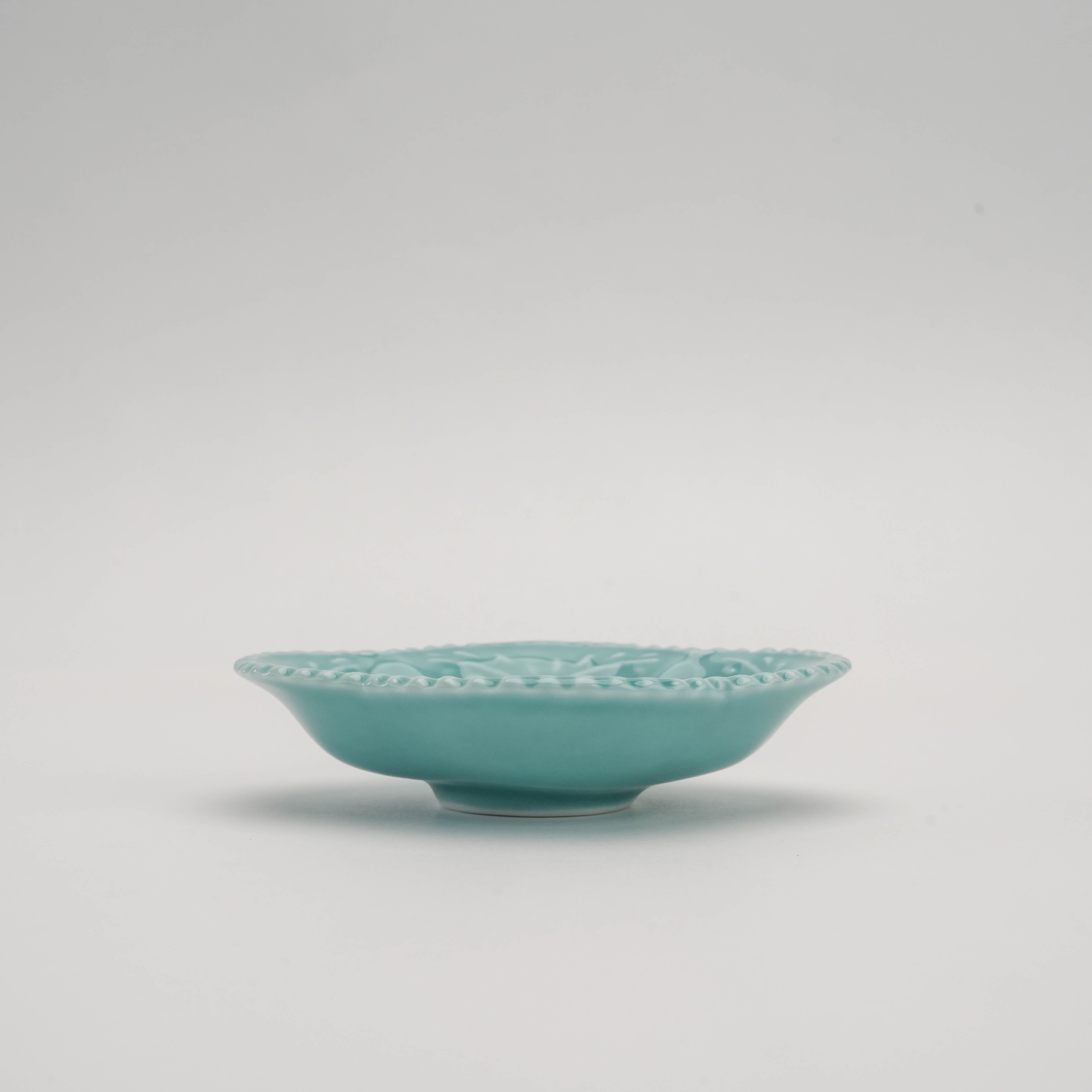 Side view of celadon Arita Ware Quince Dish showing shallow depth and raised base. Perfect for stylish condiment serving in Japanese decor.
