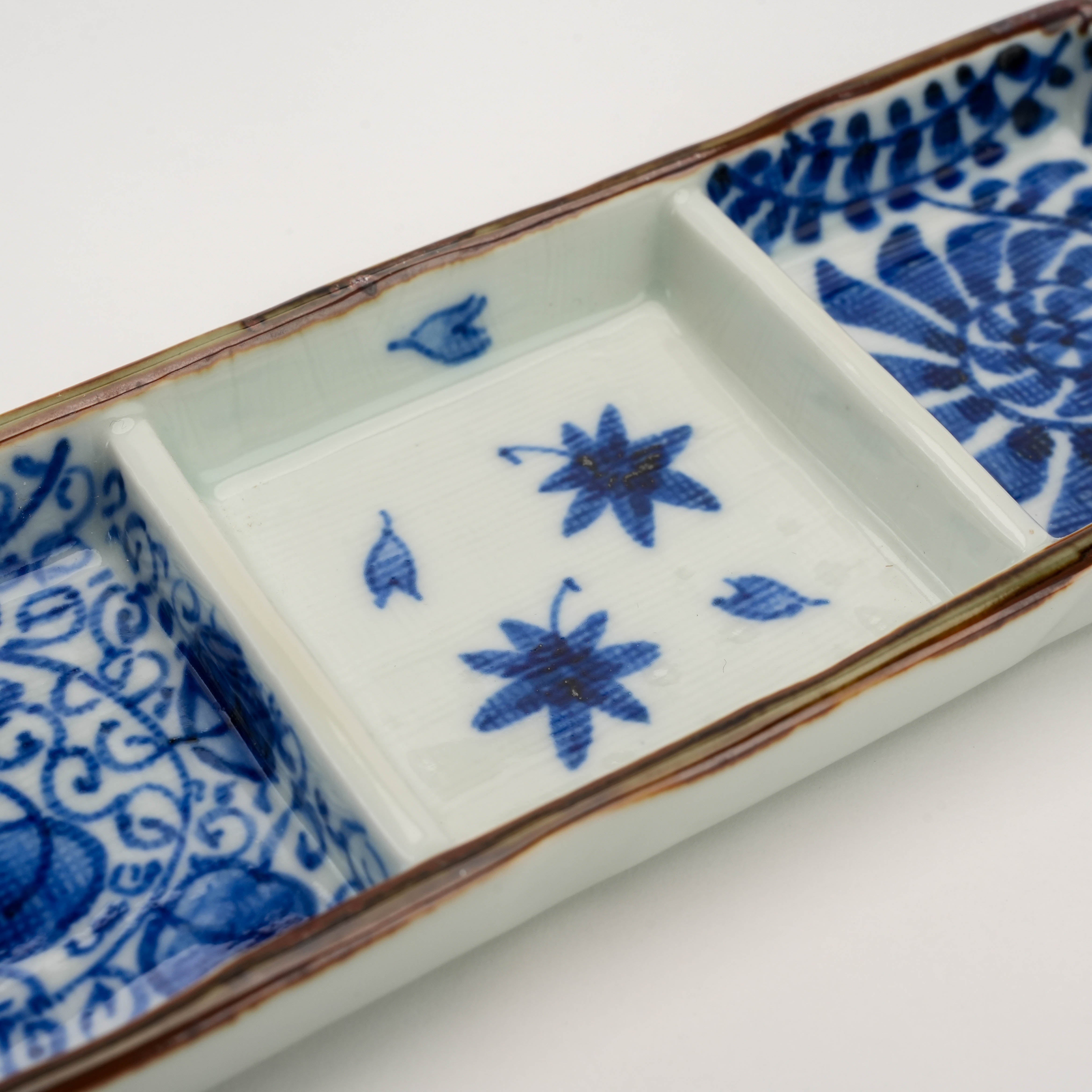 Center section of Arita Ware Triple Pattern Dish displays delicate hand-painted maple leaves, enhancing its traditional Japanese aesthetic.
