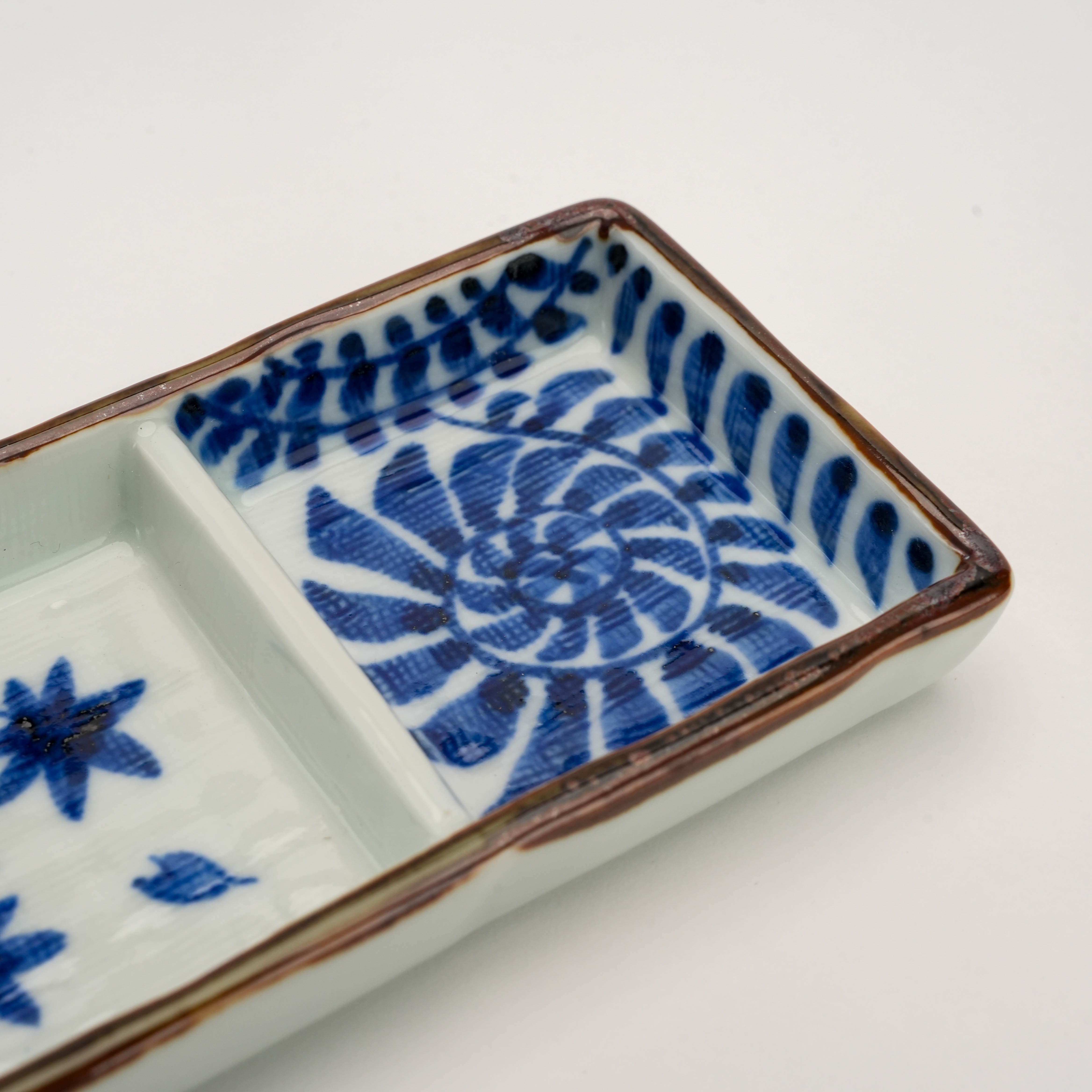 Detailed view of spiral floral motif in Arita Ware Triple Pattern Dish's third section, showcasing Kosome Indigo craftsmanship.