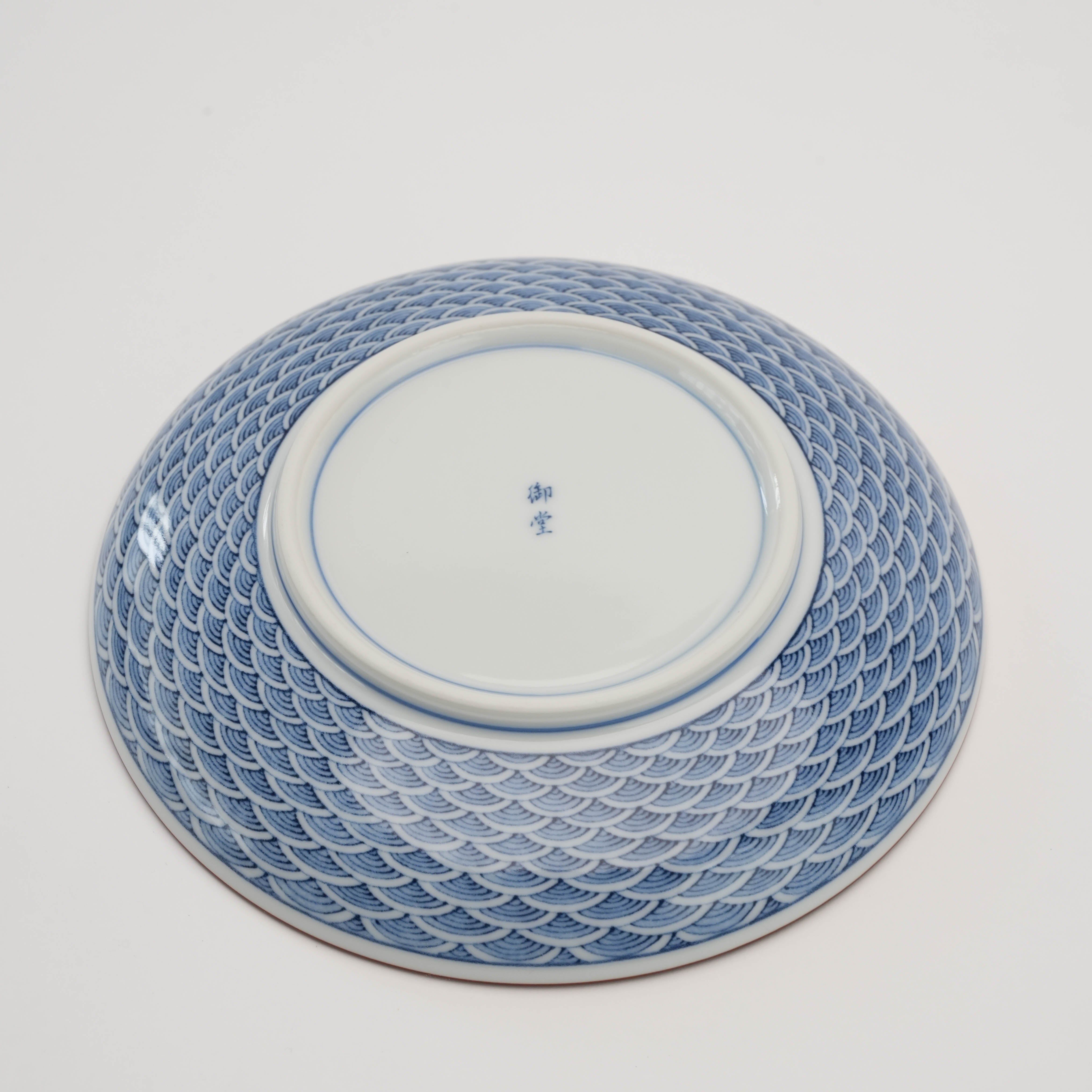 Bottom view of Arita Ware Seigaiha Small Plate showing maker's mark and full wave pattern coverage, blending traditional craftsmanship with artistry.