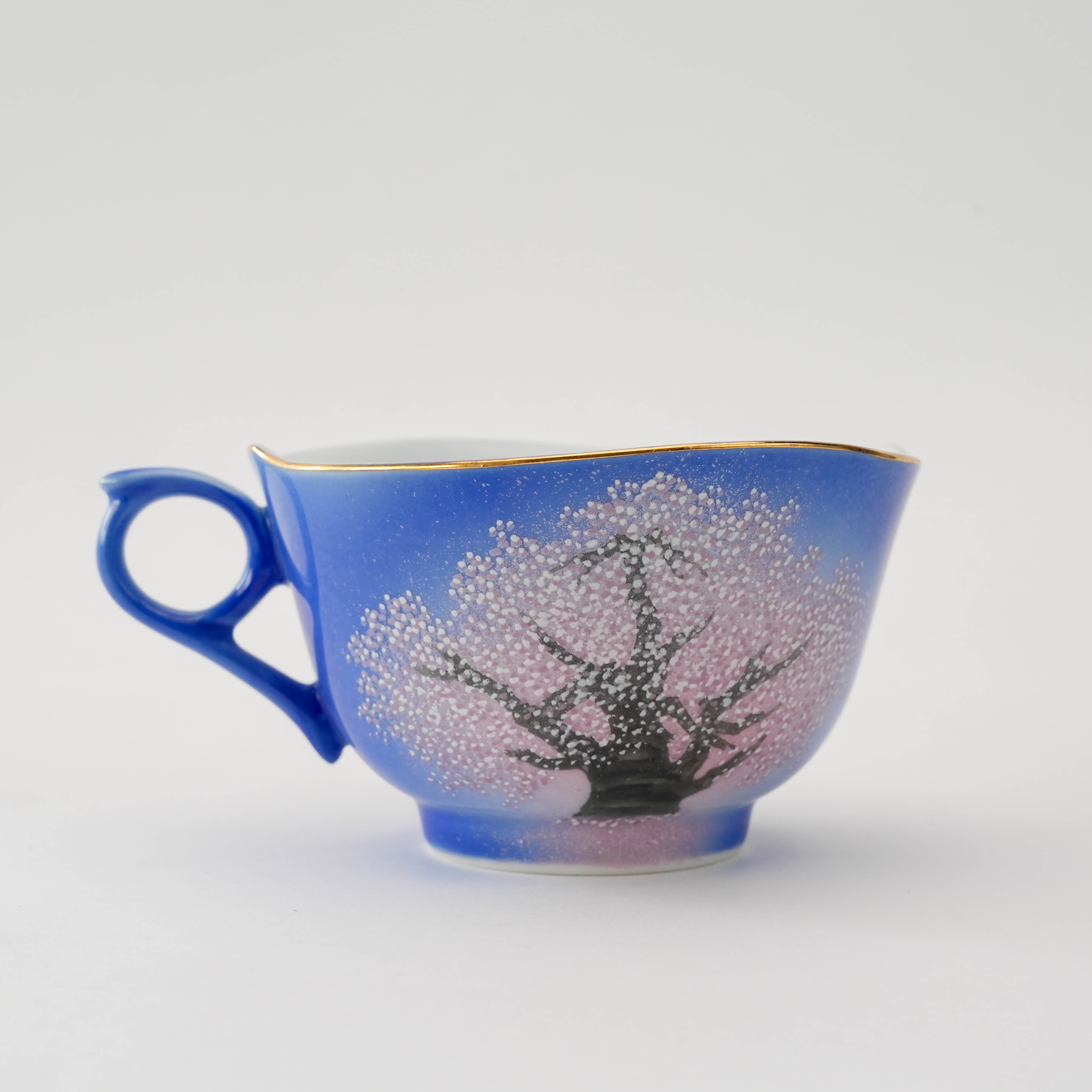 Alternate side of the Arita Yozakura Cherry Blossom tea cup, highlighting intricate blossom details and elegant gold rim.