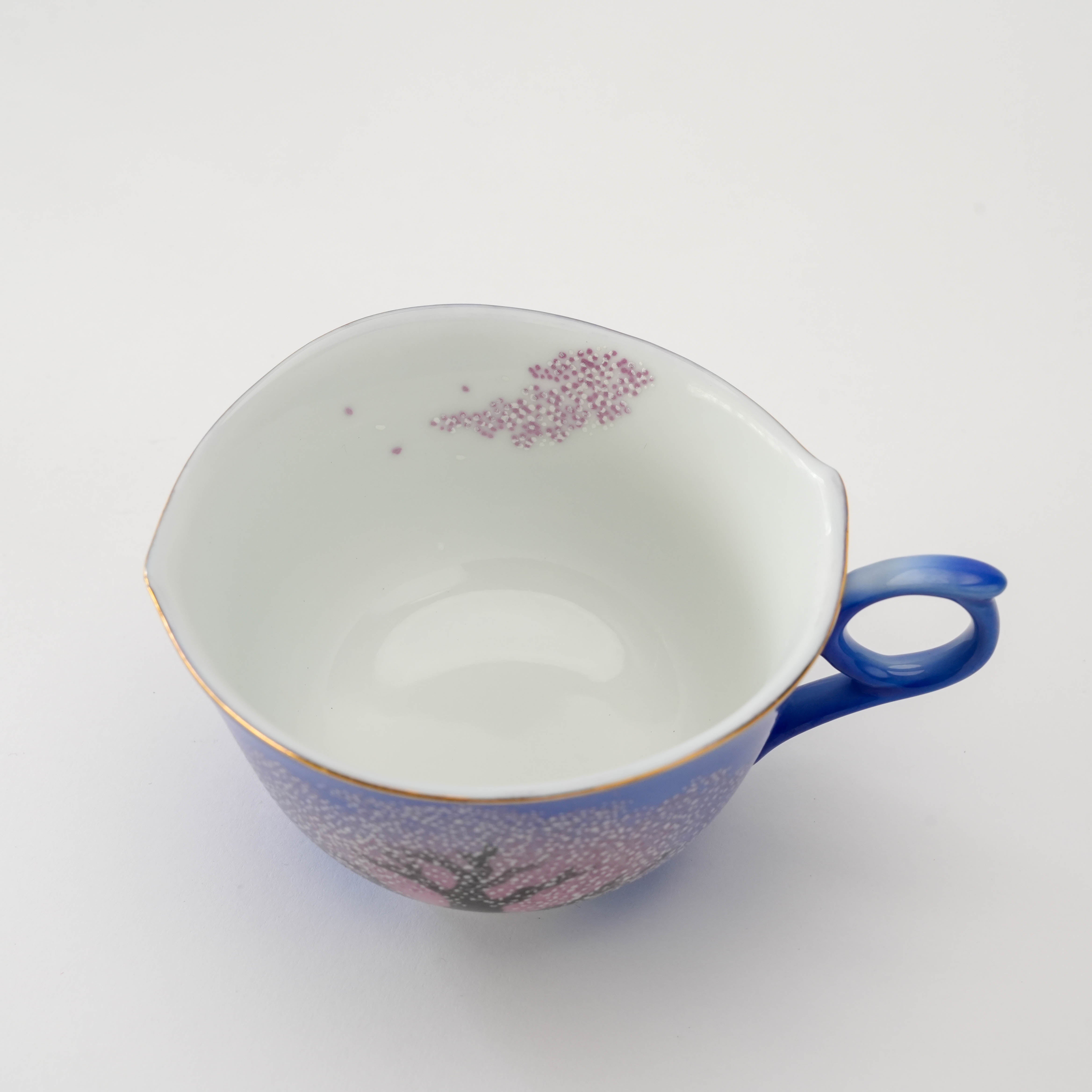 Top view of the Arita Yozakura Cherry Blossom tea cup showing interior floral accents and smooth white porcelain finish.