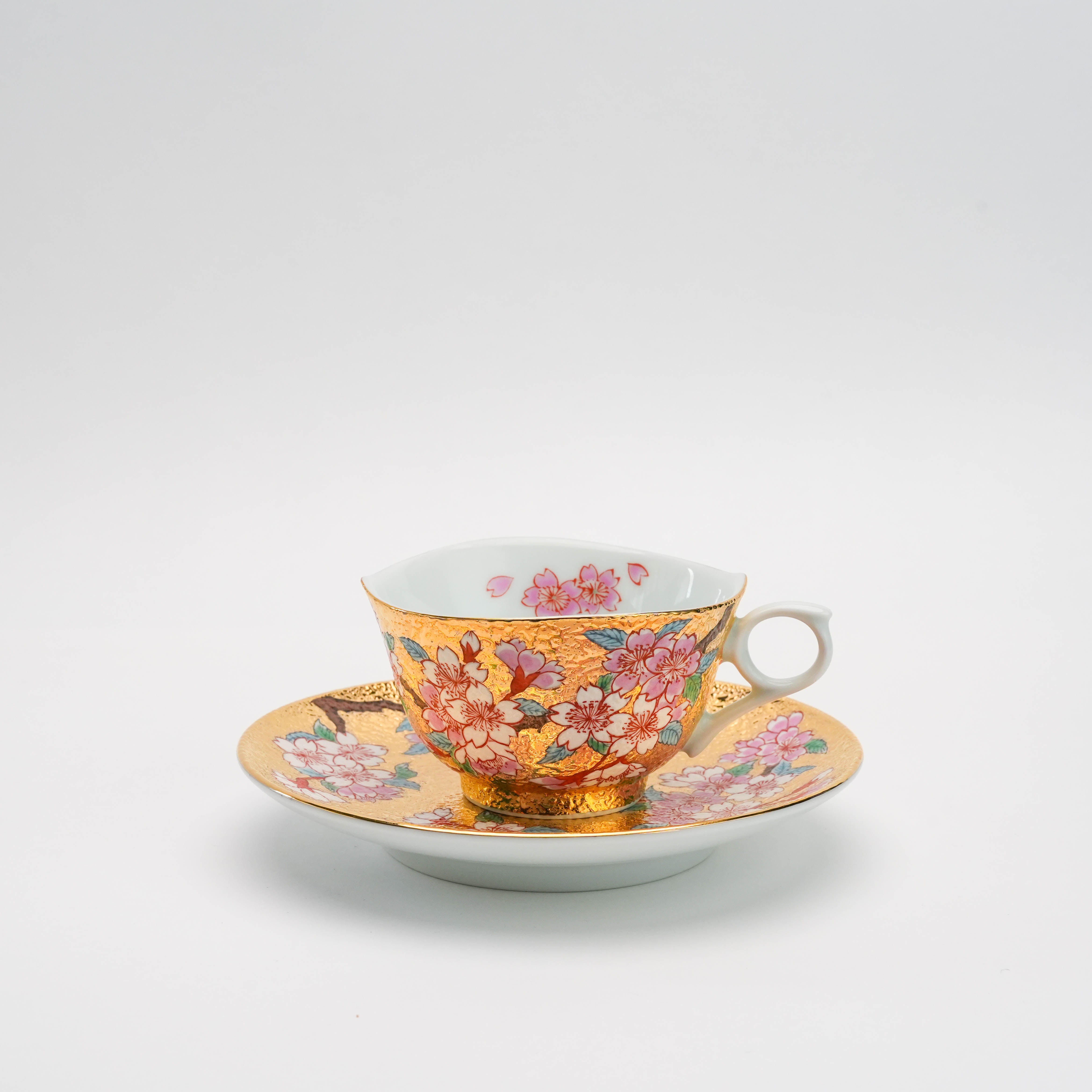 Arita Ware Sakura Cup & Saucer by Tendou Eguchi featuring gold leaf and hand-painted cherry blossoms. Elegant Japanese tea set for refined dining.