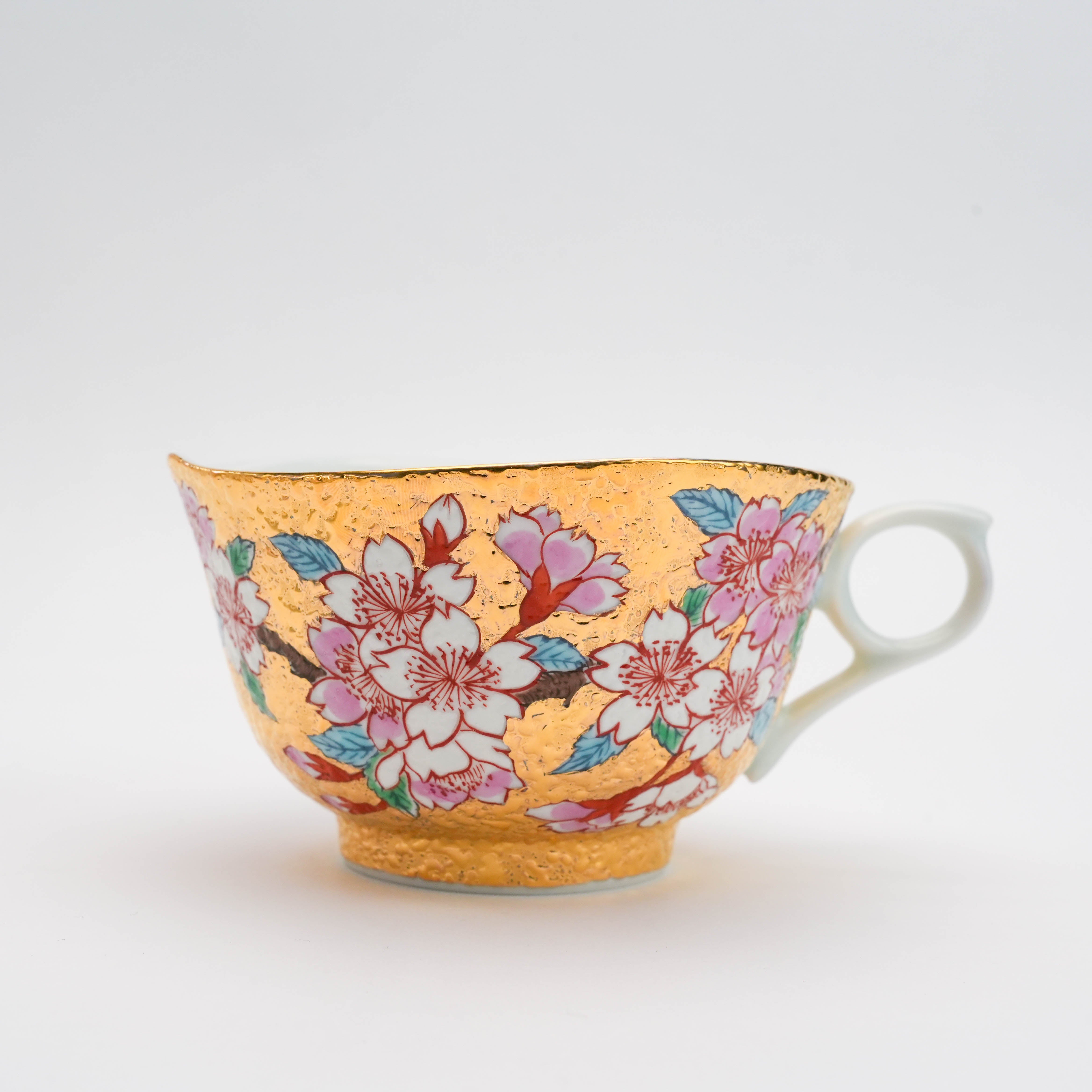 Detailed side profile of the Gold Sakura Cup from the Arita Ware tea set. Hand-painted cherry blossoms enhance the traditional Japanese design.