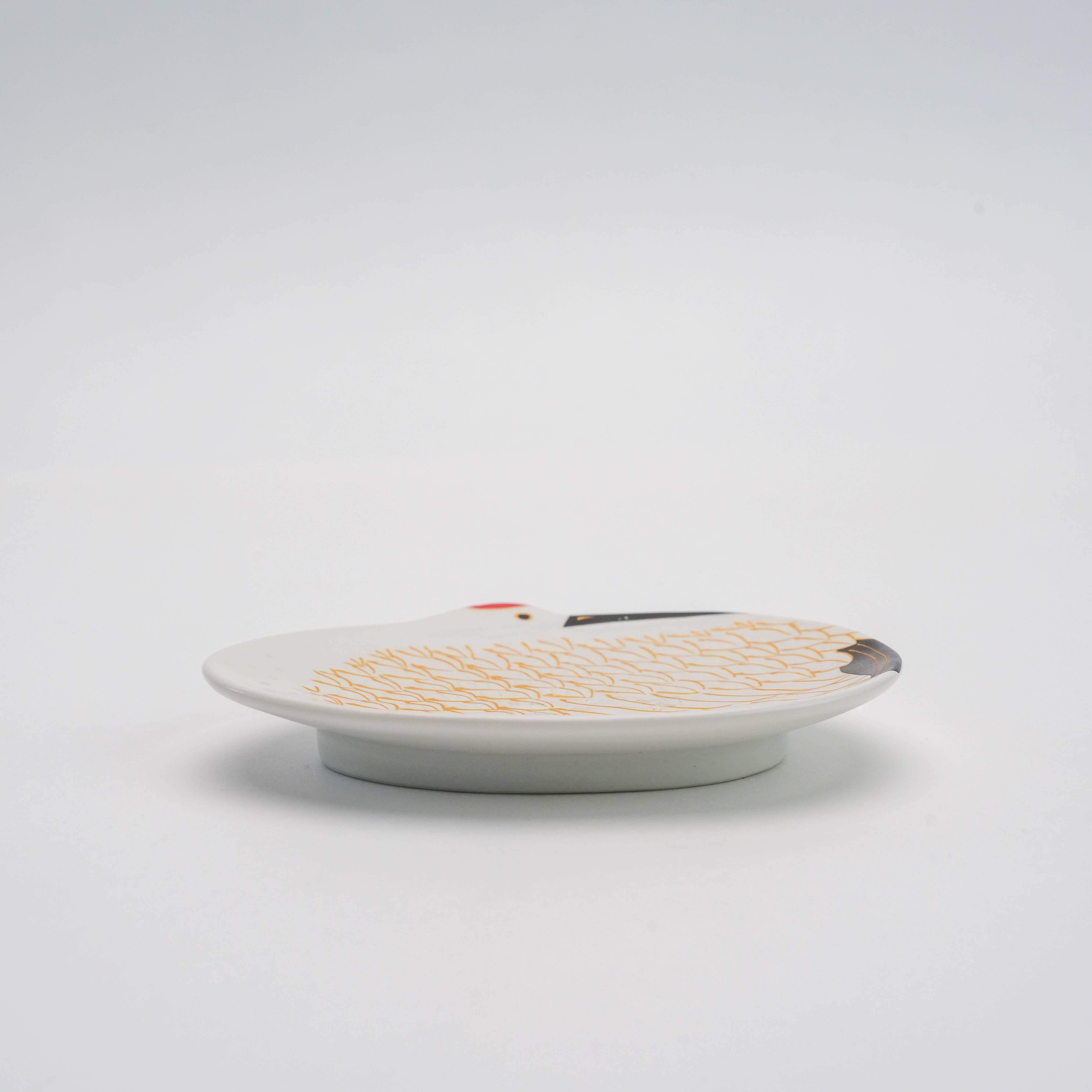 Side view of Arita Ware Snow-Covered Gold Feather Crane Small Dish showing its shallow depth and fine porcelain craftsmanship. Perfect for refined table settings or gifting.