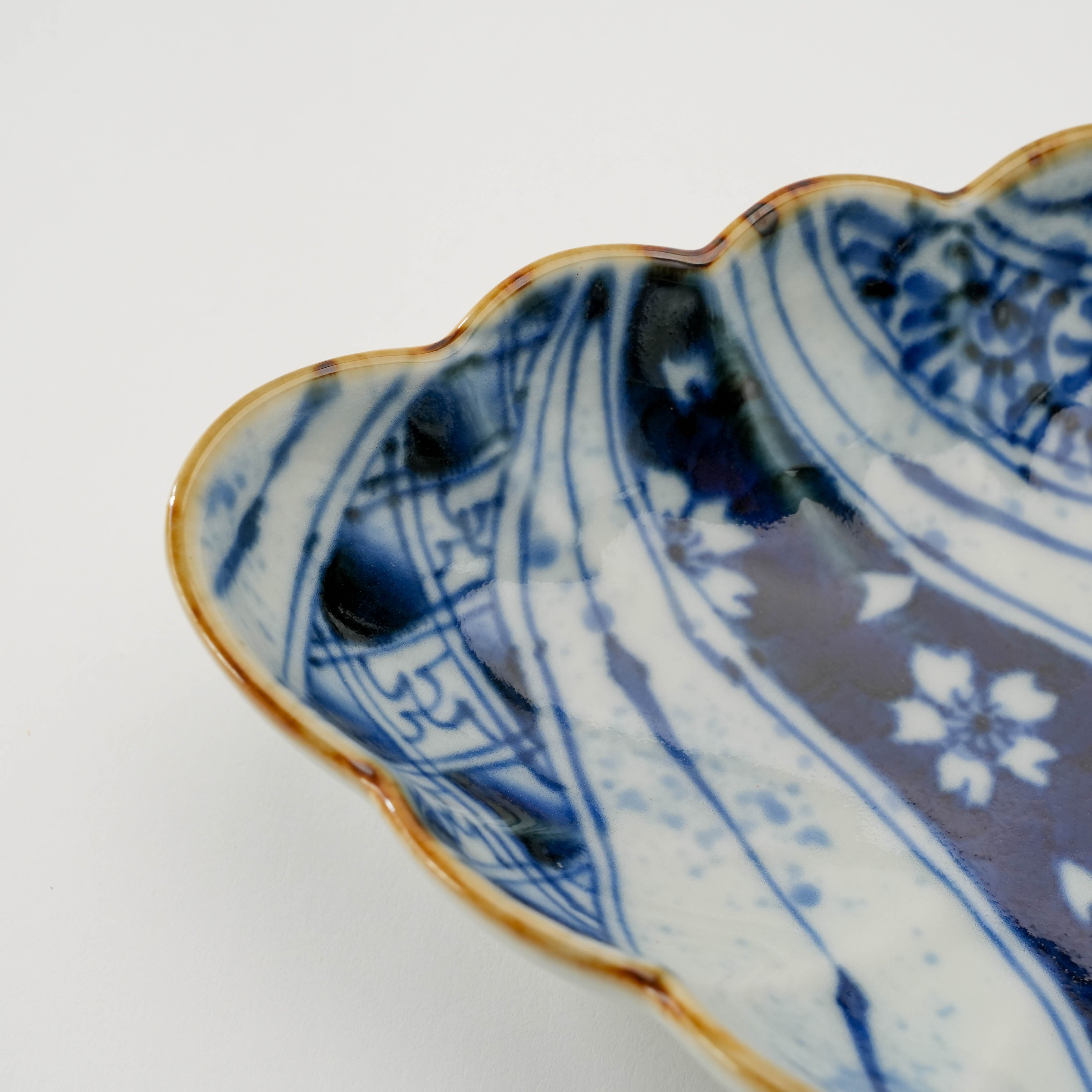 Detail of the Arita Ware Diamond Bowl's hand-painted chrysanthemum and wave patterns with gold-accented rim, ideal for refined dining settings.