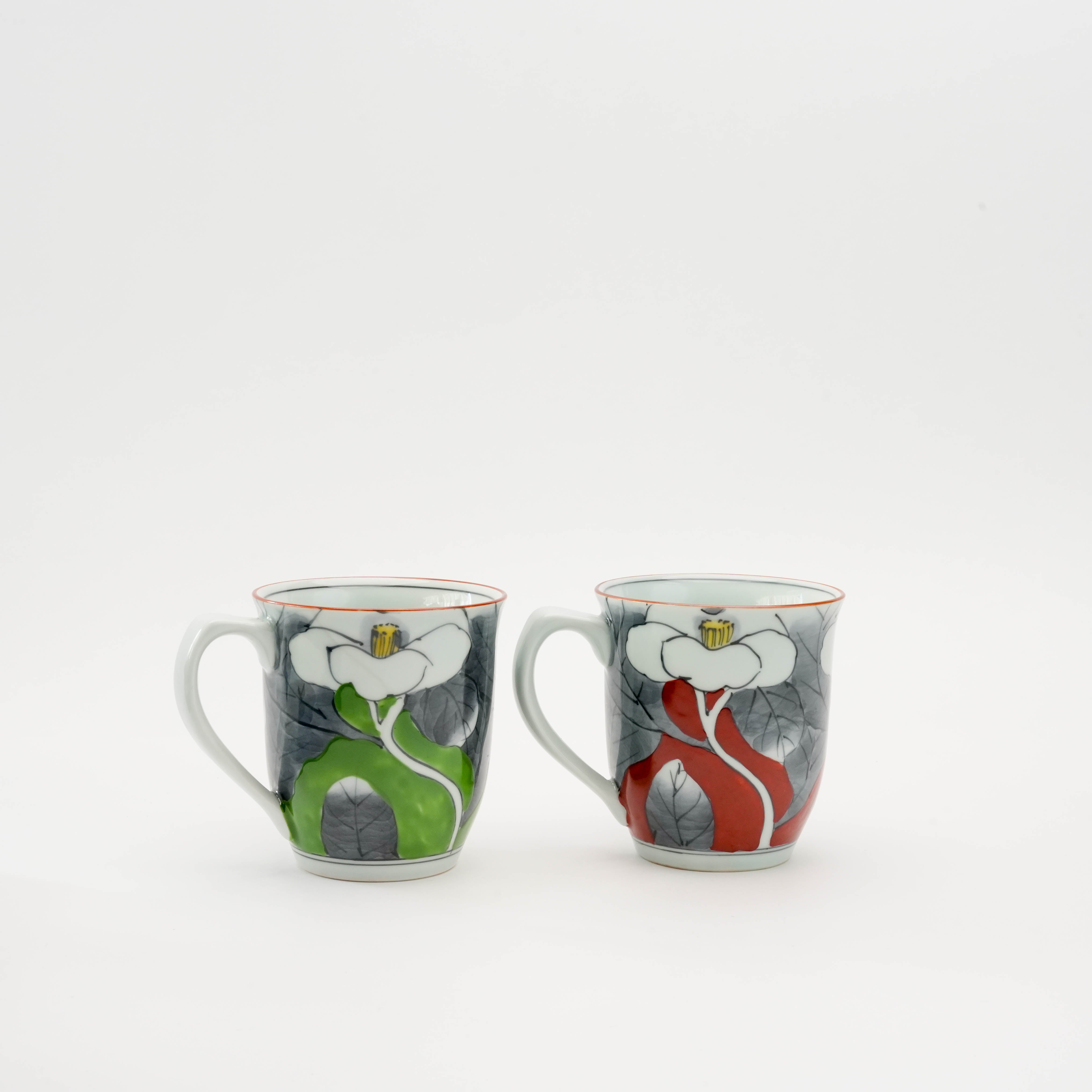 Front view of Arita Ware Pair Mug Set with red and green camellia motifs, blending Japanese tradition and elegance in drinkware.