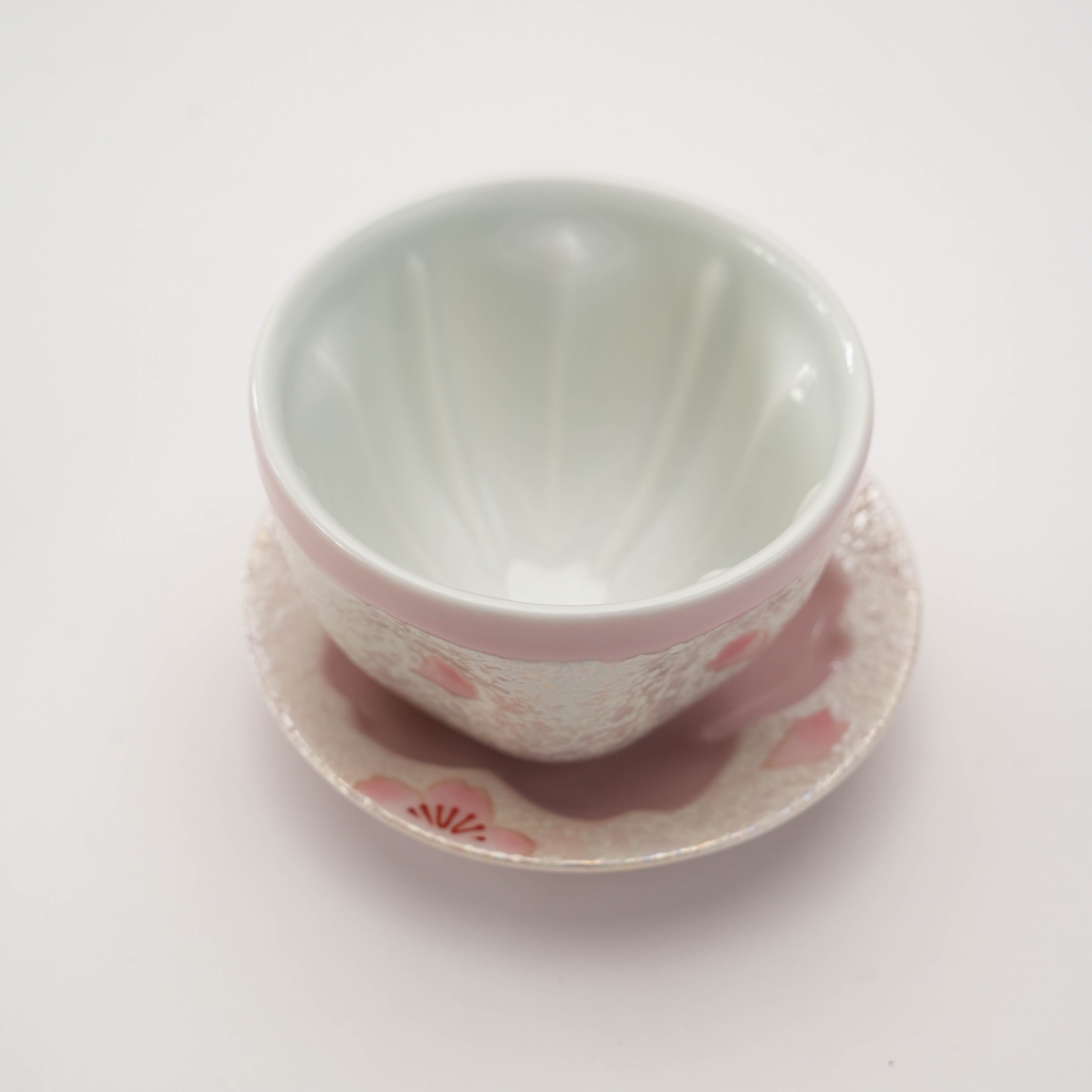 Interior view of Arita Ware Pink Cherry Blossom Small Teacup with Saucer, showcasing smooth white glaze and floral accents.