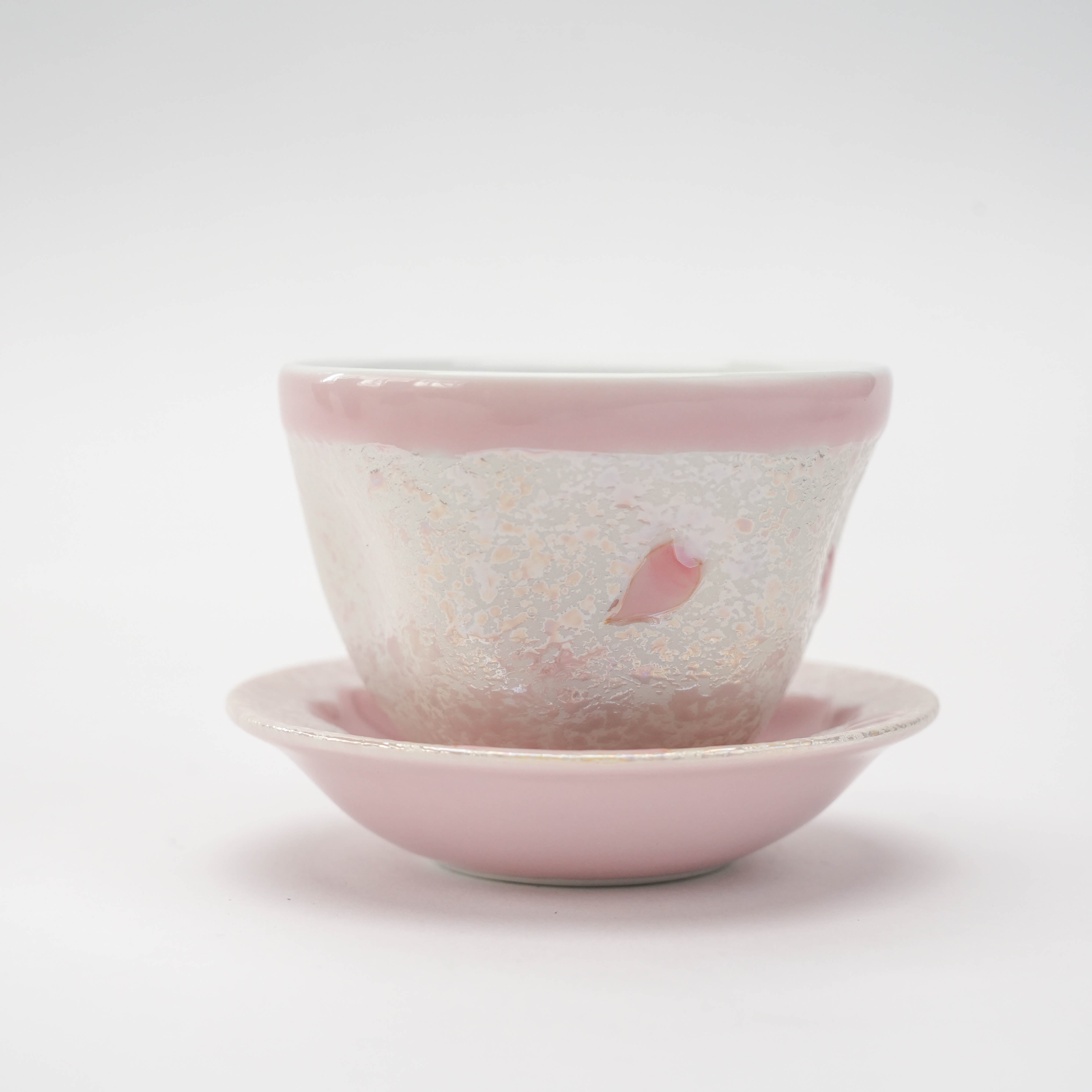 Close-up of Arita Ware Small Teacup with Saucer, highlighting pink cherry blossom motif and shimmering ceramic texture.