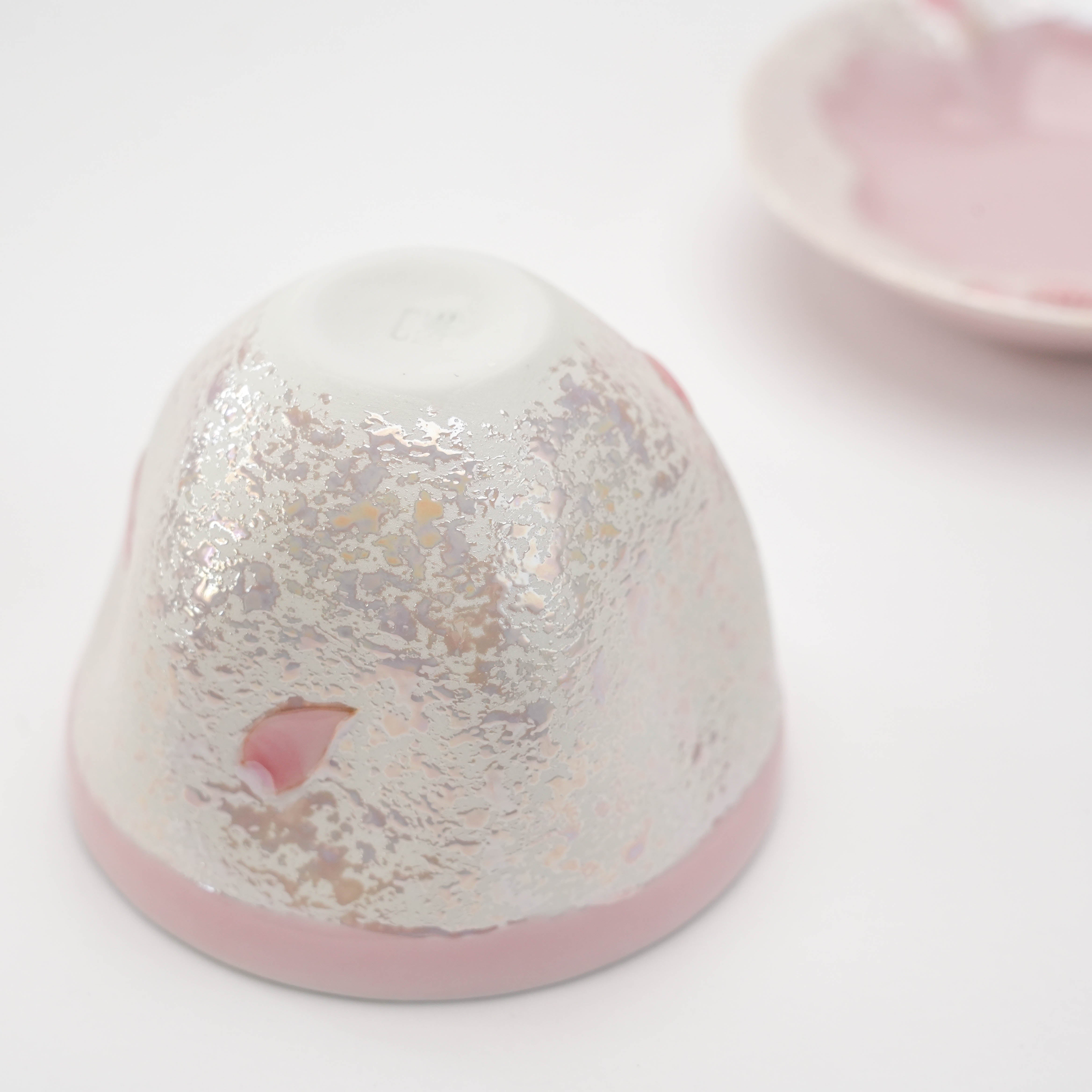 Bottom view of Arita Ware Pink Cherry Blossom Teacup, showing textured glaze and delicate petal detail, part of Japanese ceramic set.