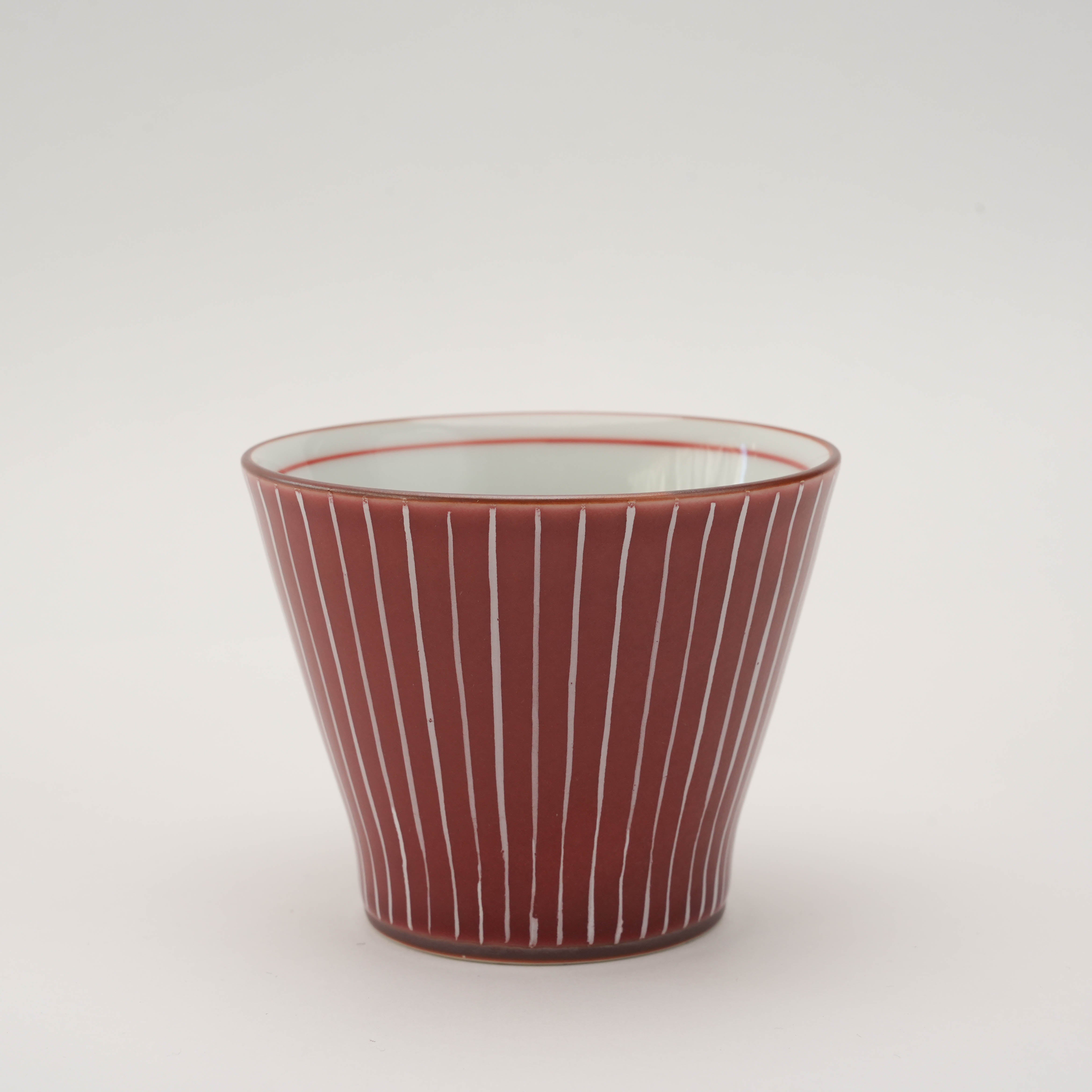 Red Shiraito Teacup with vertical white lines and flared shape. Handcrafted Japanese drinkware for elegant table settings.