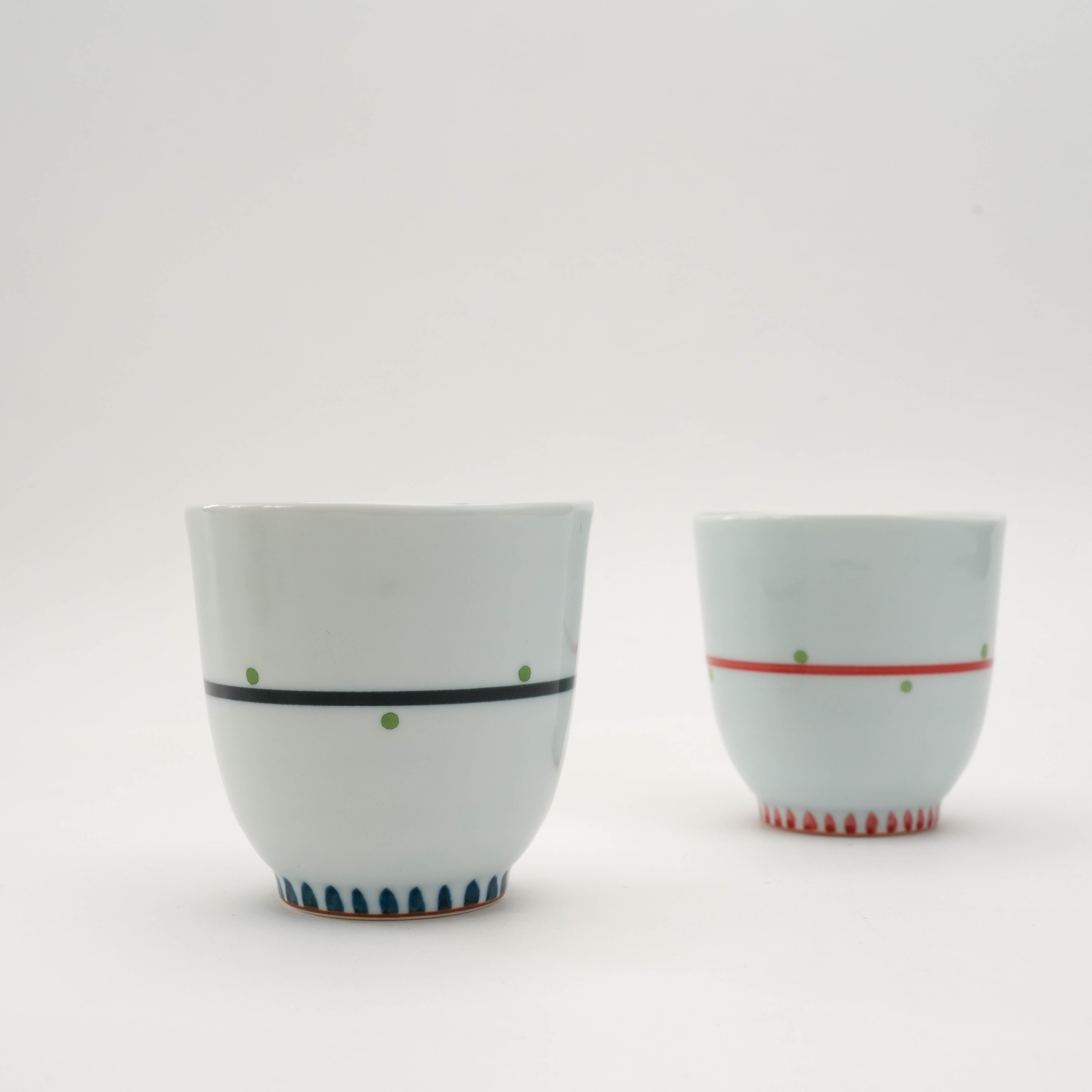 Minimalist exterior of Arita Ware Owl Teacups in red and blue. Japanese porcelain drinkware with hidden owl surprise.