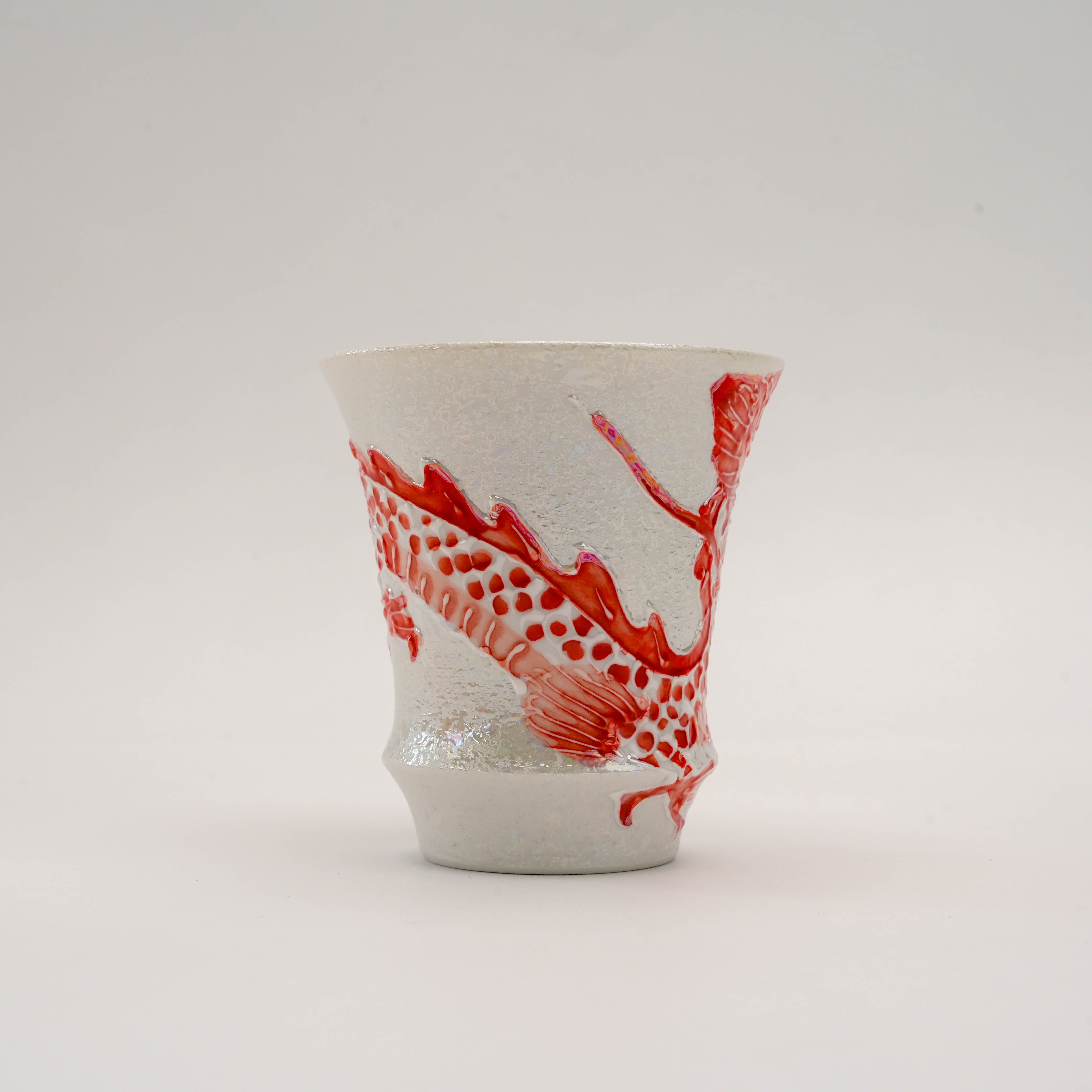 Detailed side of the Artisan Collection Fire Dragon Sake Glass showing the dragon's body in vivid red against a shimmering silver porcelain base.