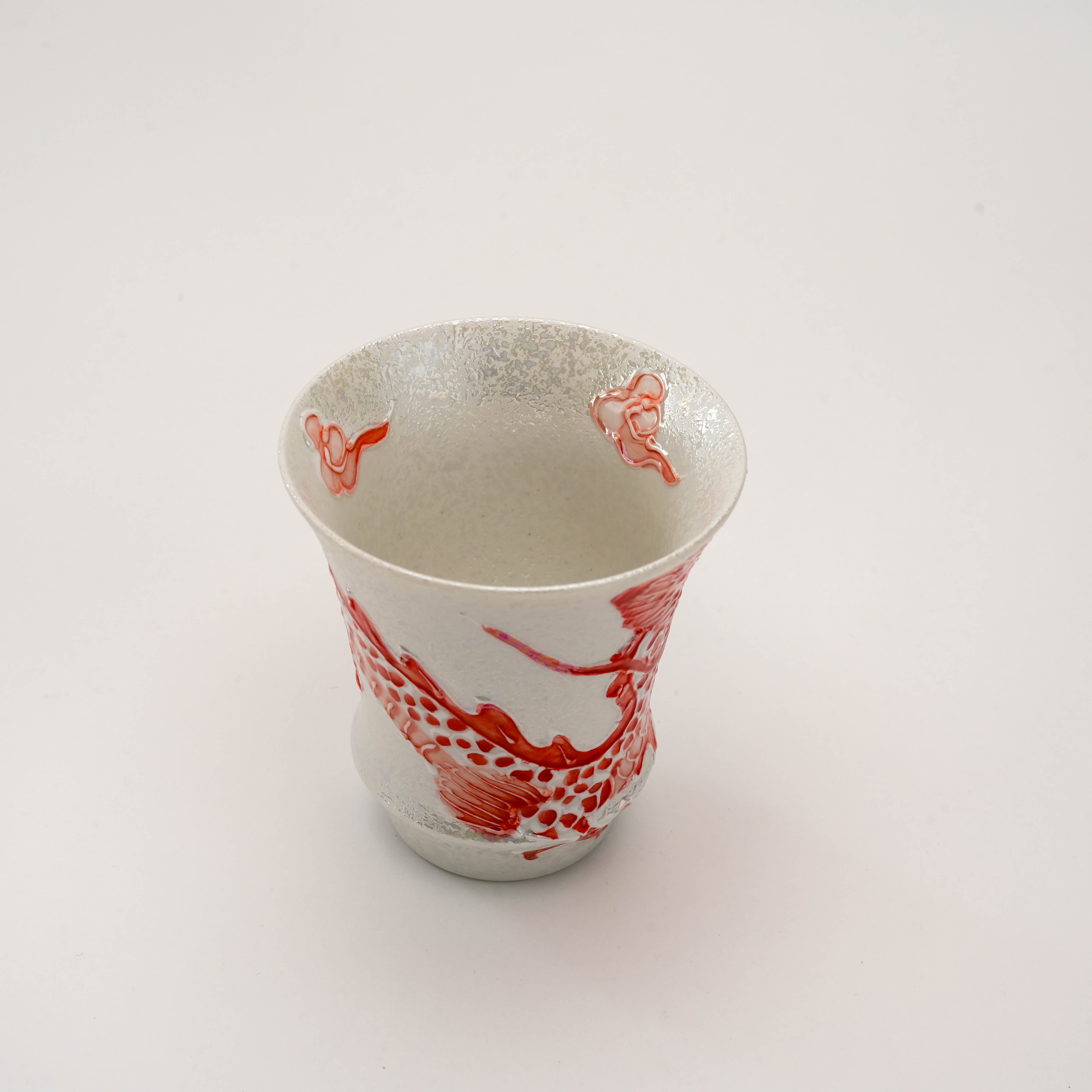 Top-down view of the Fire Dragon Sake Glass revealing the interior silver glaze and red dragon accents curling over the rim.