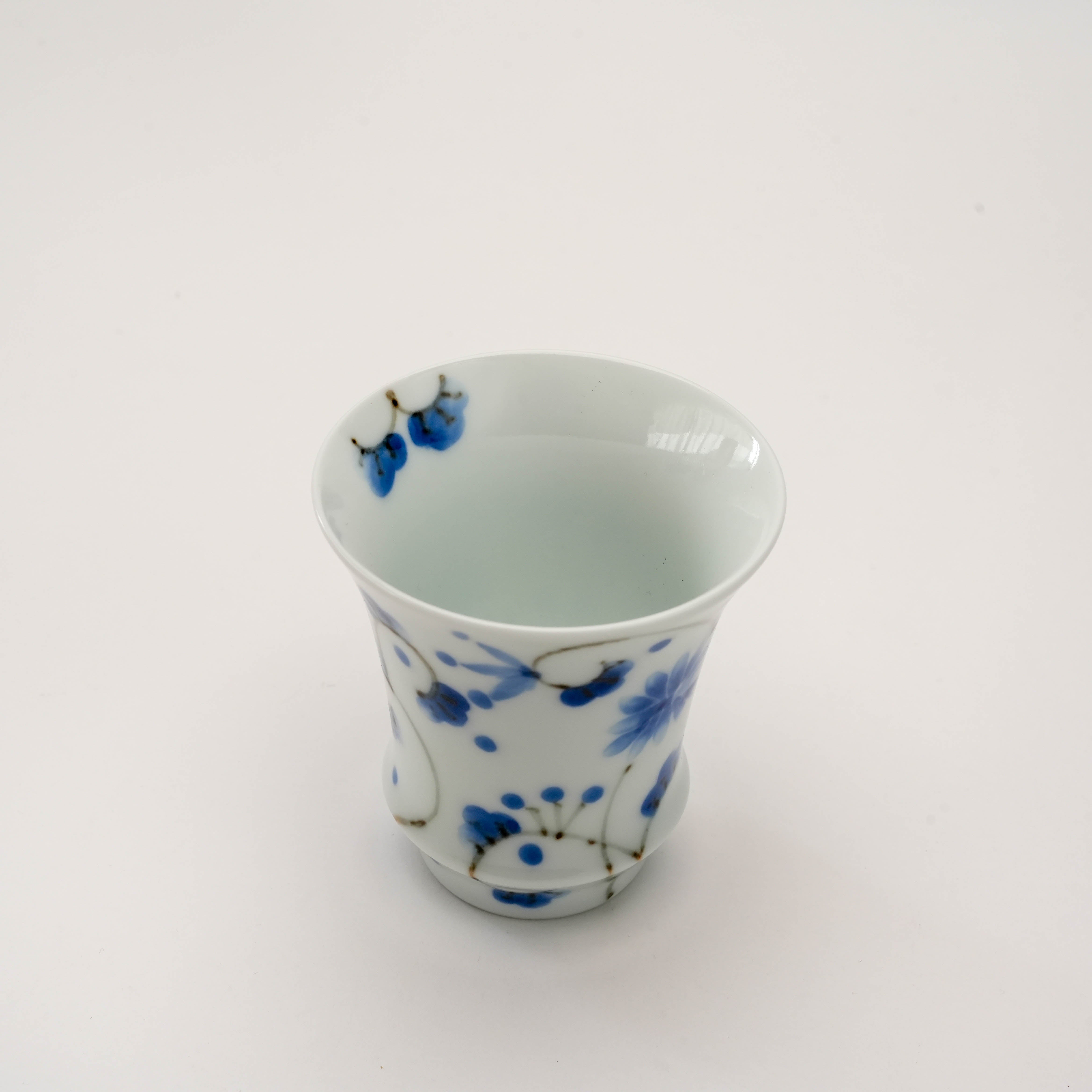 Top view of Arita Ware Sake Glass - Hotaru Arabesque highlighting the smooth porcelain interior and artistic floral exterior, ideal for chilled sake.