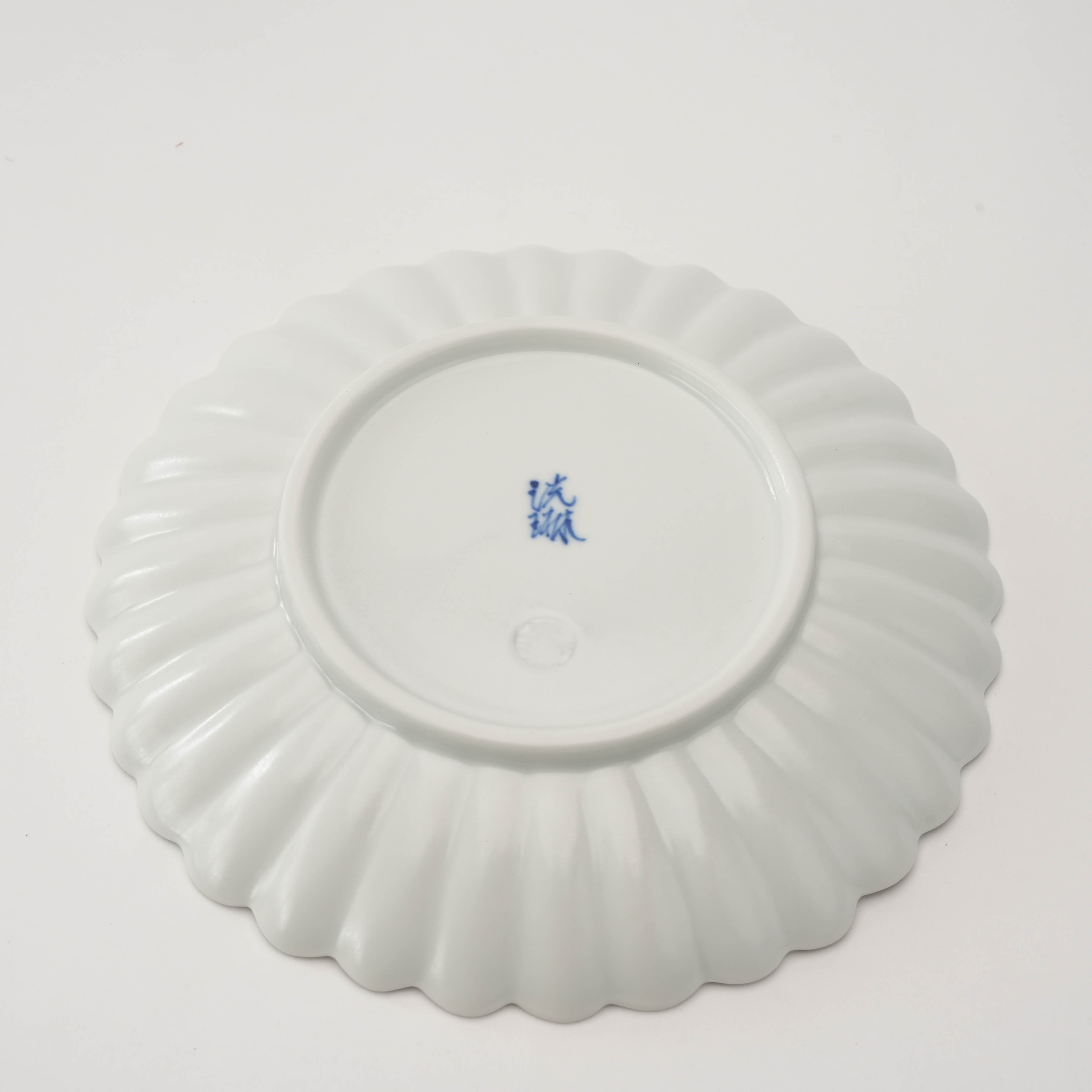 Underside of Arita Ware Chrysanthemum Plate showing maker’s mark and fluted petal design, 15cm matte white porcelain for stylish serving.