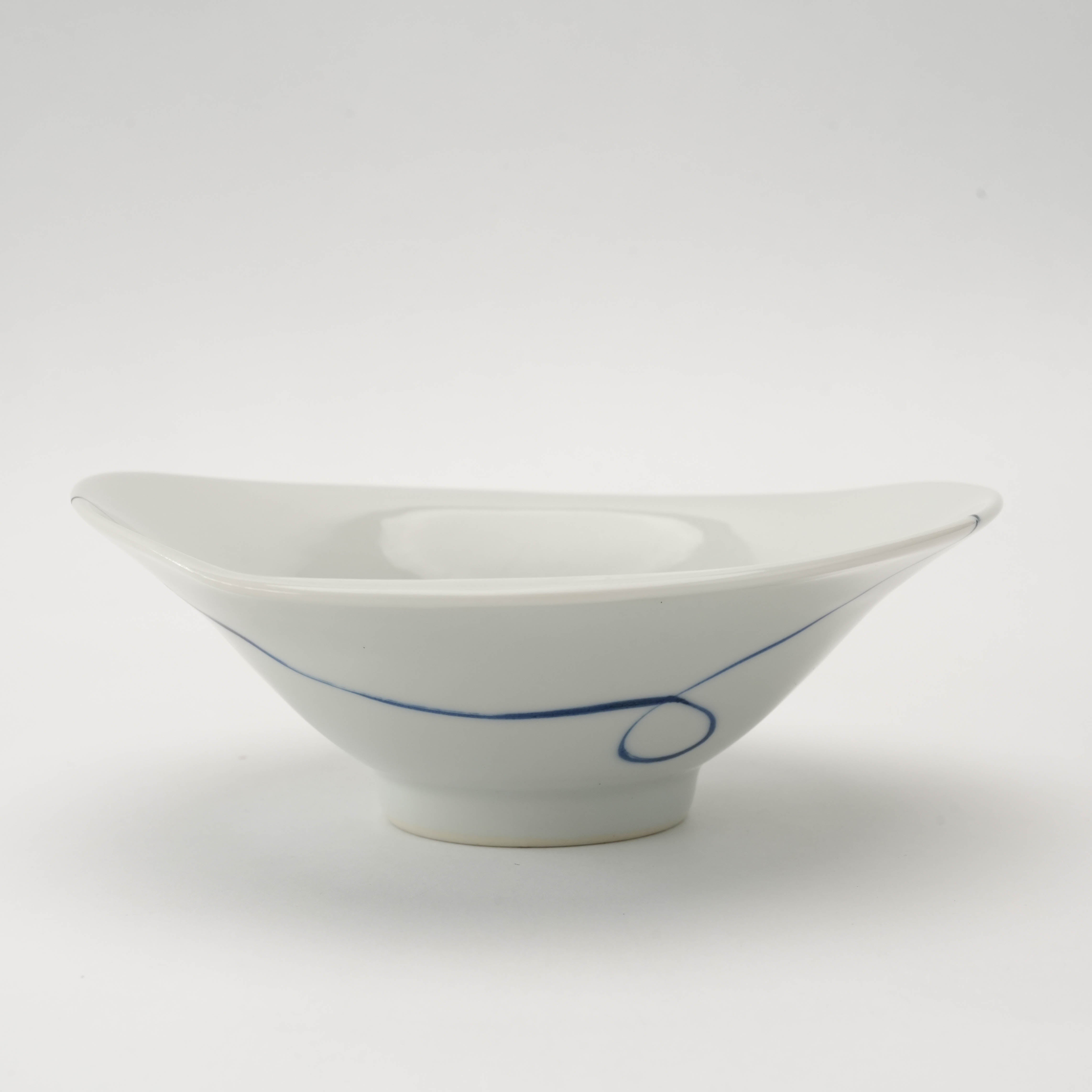 Side profile of Arita Ware Twisted Small Bowl featuring a flared asymmetrical shape and delicate indigo line, blending tradition with modern design.