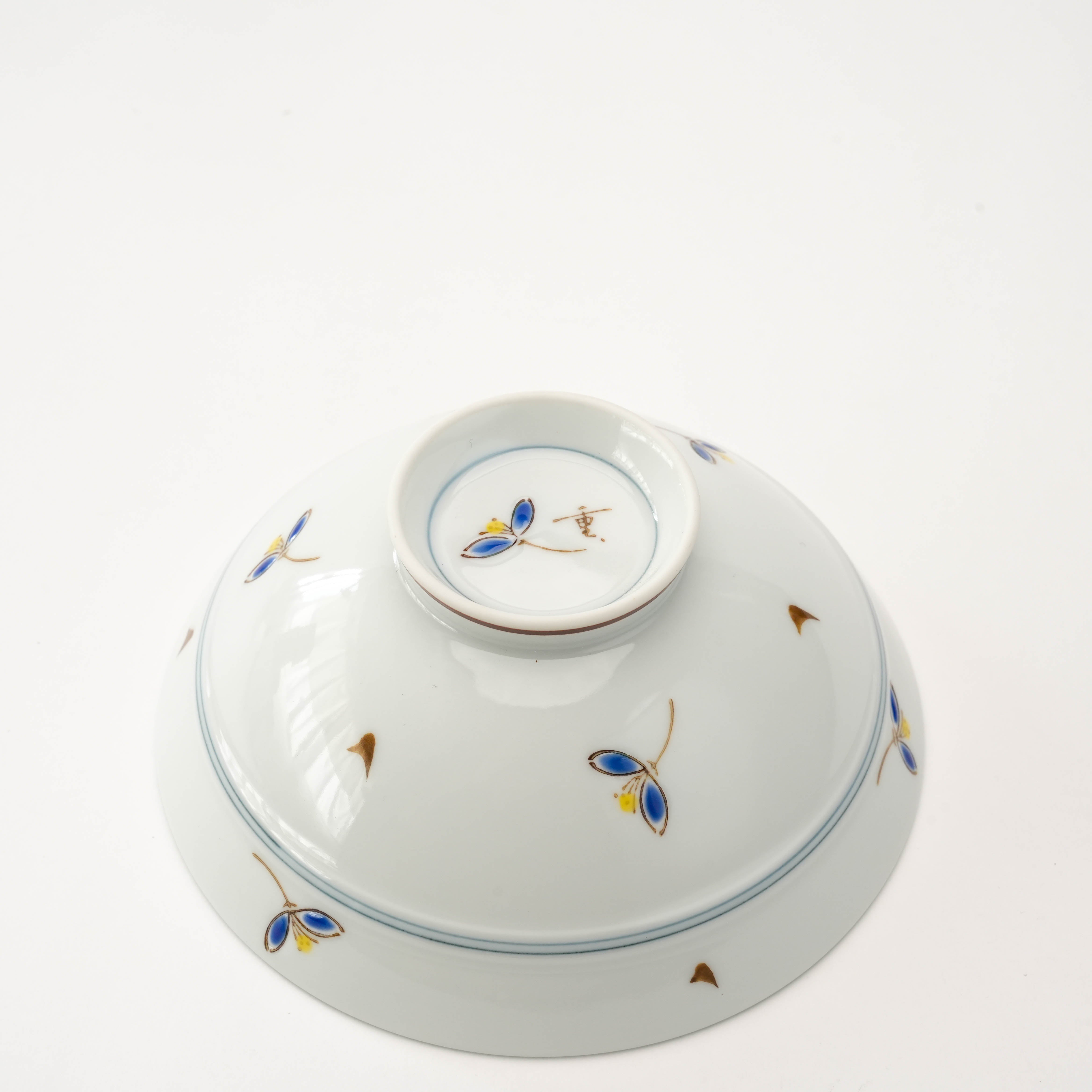 Bottom view of Arita Ware Akane Grass Rice Bowl highlighting the floral design and signature detailing on the base, perfect for elegant dining.