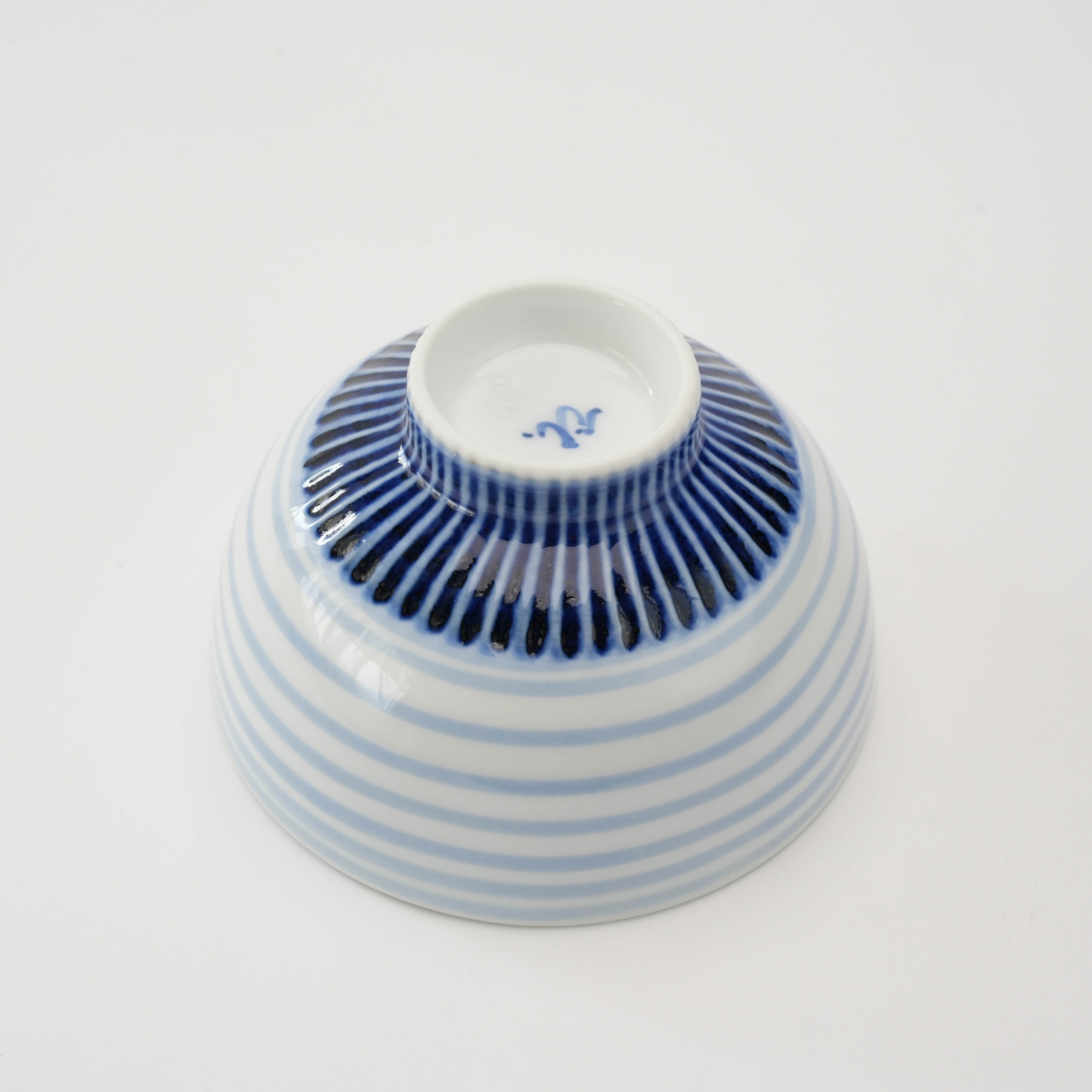Bottom view of Arita Medaka Rice Bowl featuring detailed indigo base pattern and maker’s mark, highlighting traditional Japanese ceramic artistry.
