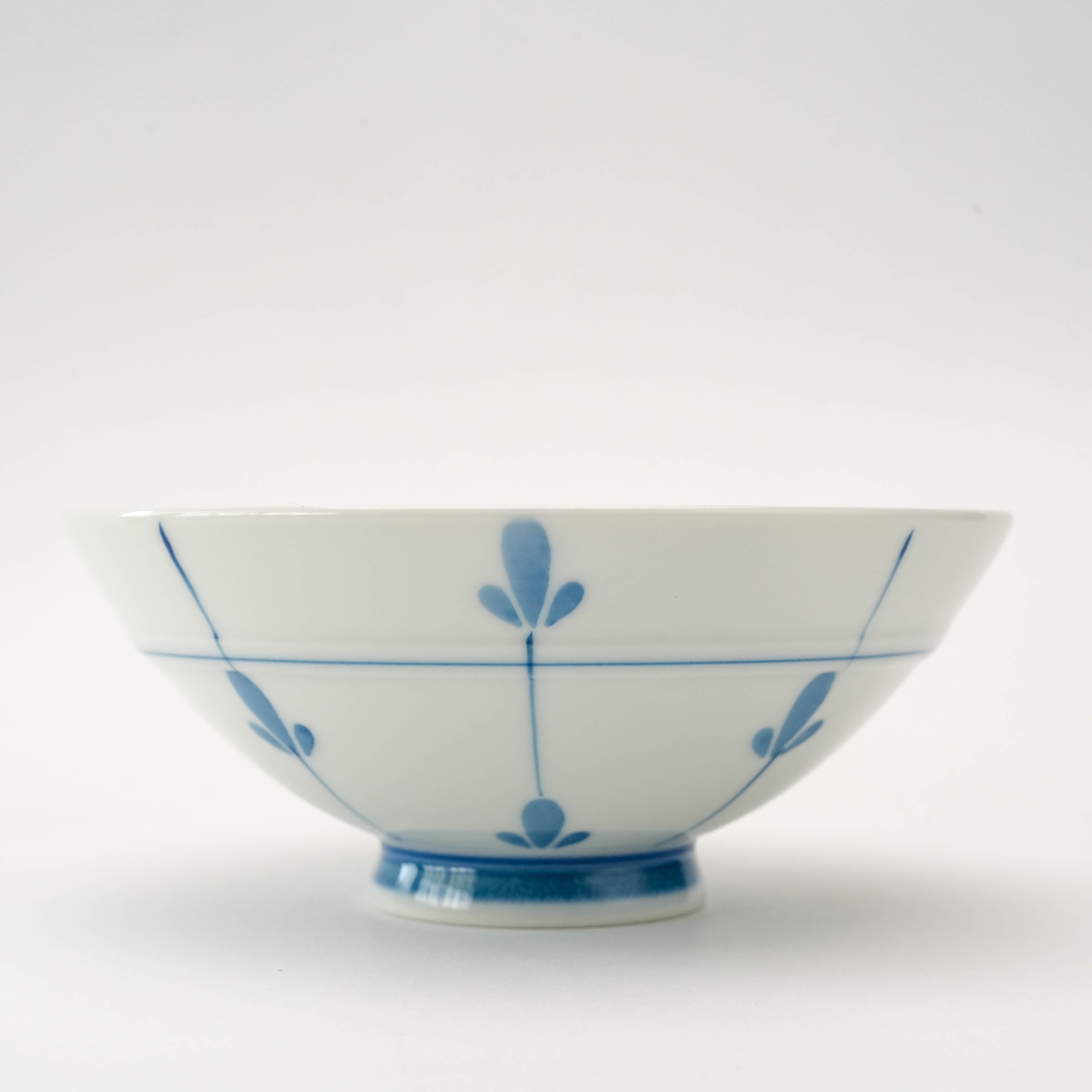 Close-up of Arita Ware Sprout Rice Bowl showing delicate blue sprout pattern and fine porcelain craftsmanship, perfect for elegant dining settings.