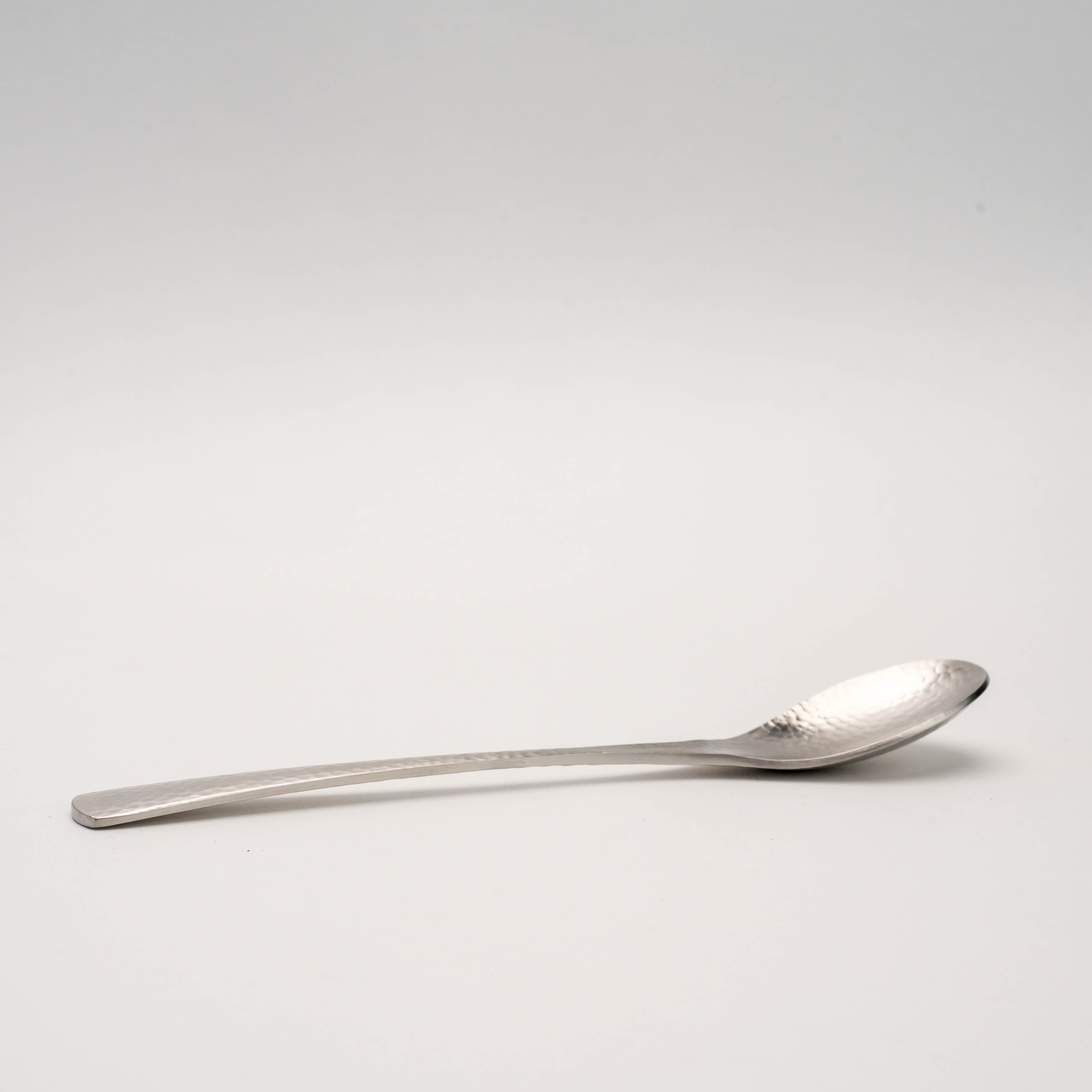 Side view of Tsubamesanjo Spoon - Hammered Finish highlighting its curved design and artisanal hammered texture for premium flatware collections.