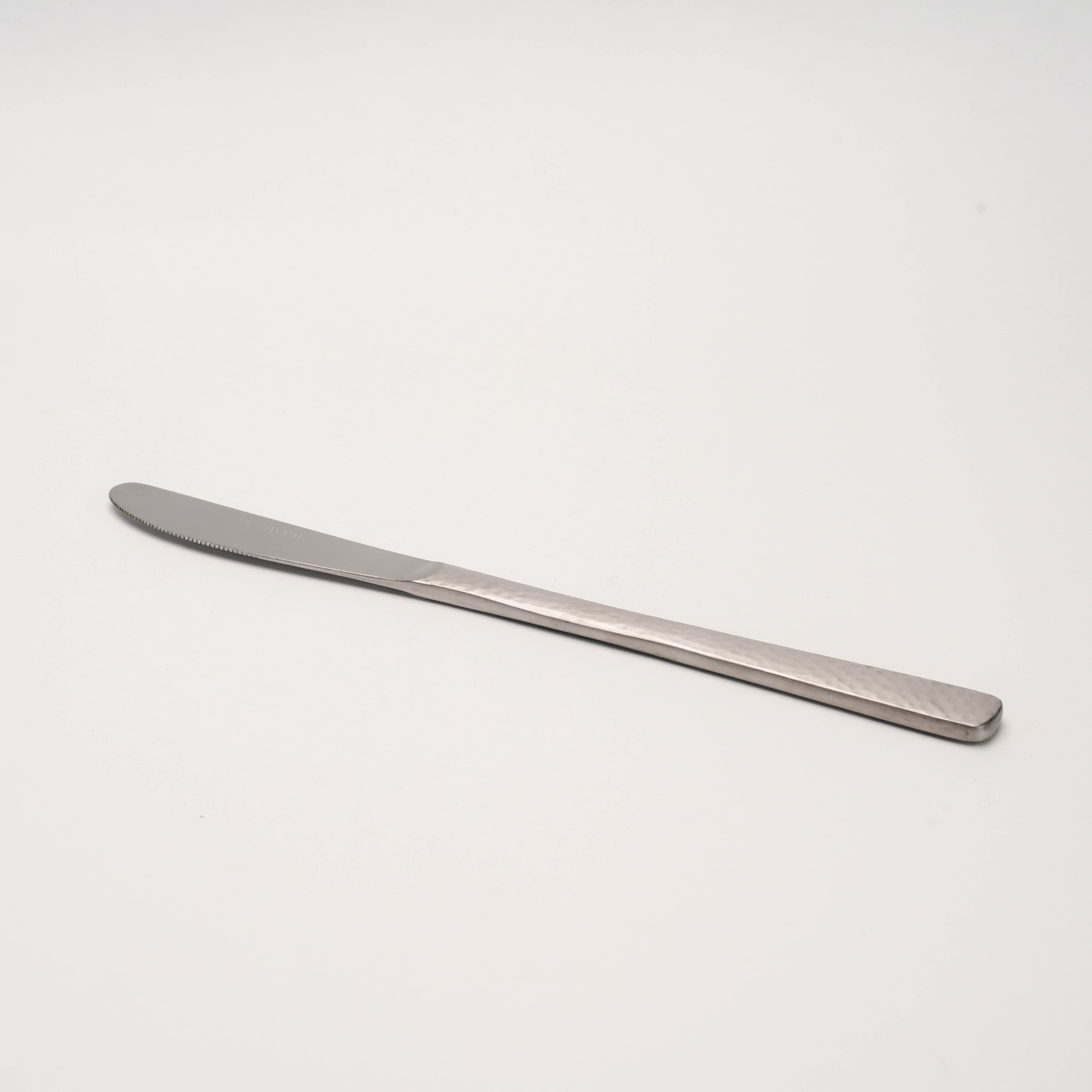 Side view of Tsubamesanjo Nagomi Wafu Knife-Hammered, emphasizing its long, slim profile and hammered stainless steel handle.