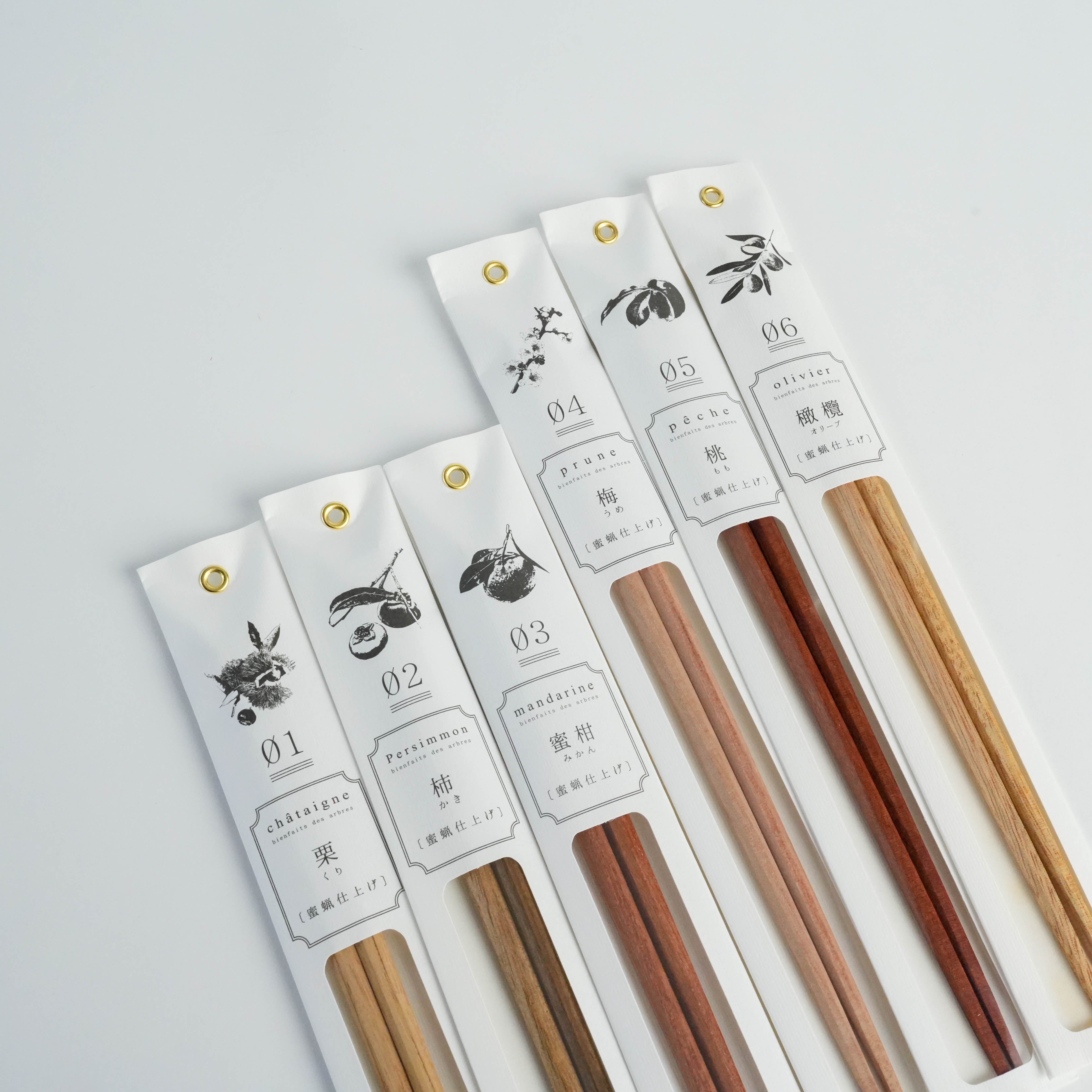 Set of Kawai Tetoca Chopsticks in assorted natural woods, including Peach Wood, displayed in stylish labeled packaging for gifting or dining.