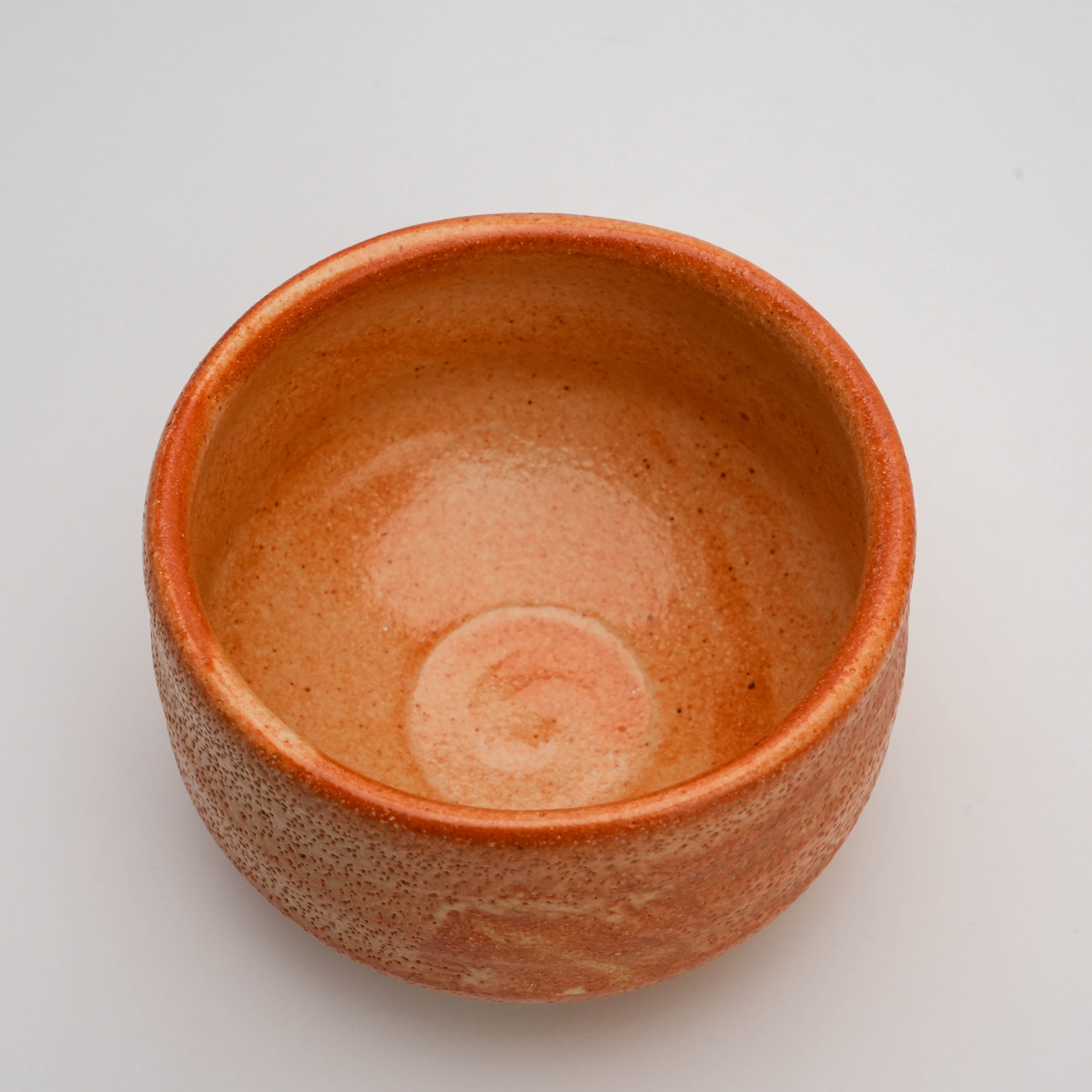 Top view of Minoyaki Matcha Bowl - Persimmon Glaze revealing smooth interior and spiral base, designed for traditional tea ceremony use.