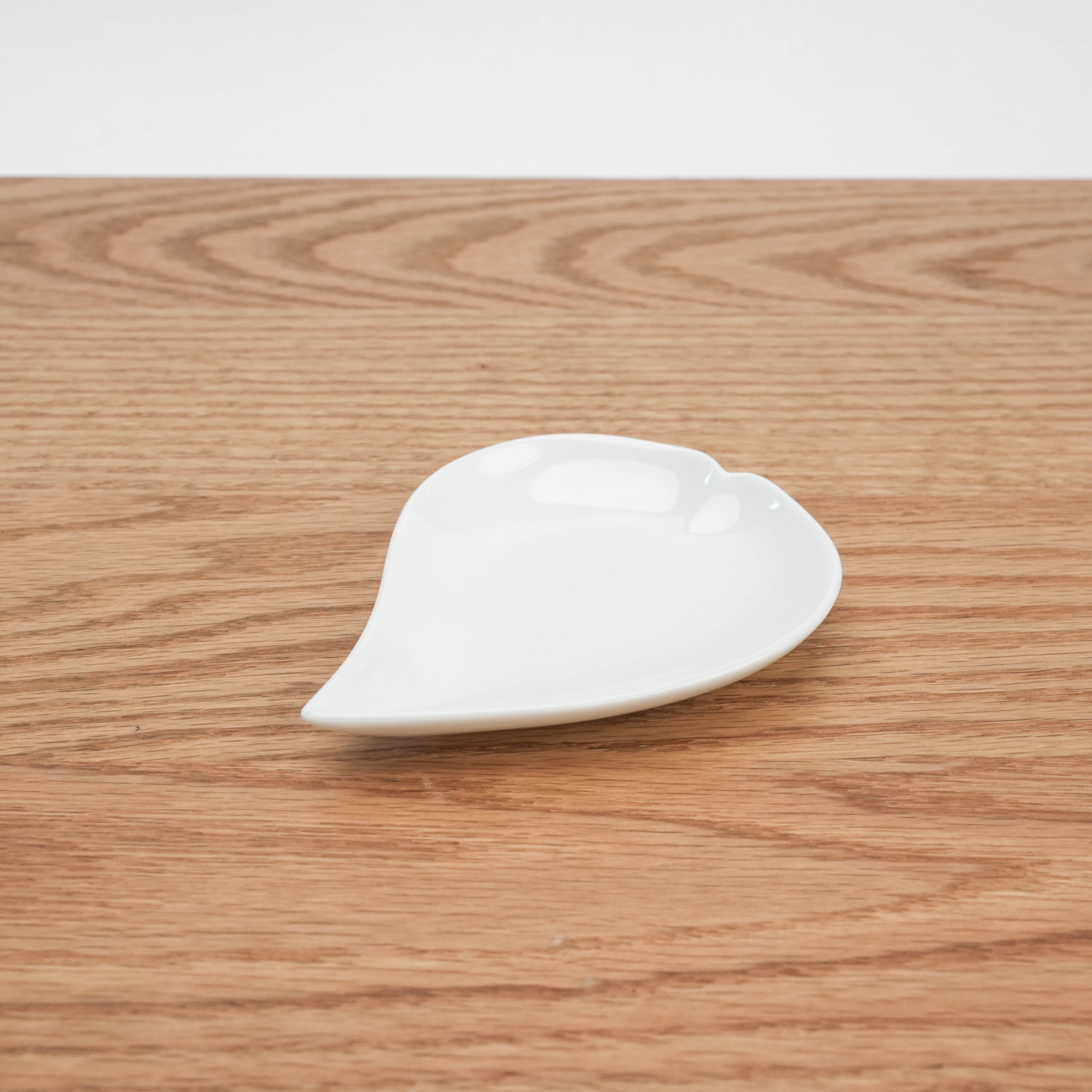 Single Mino Ware Sakura Petal Plate on wood surface, showcasing delicate cherry blossom-inspired design for refined table settings.