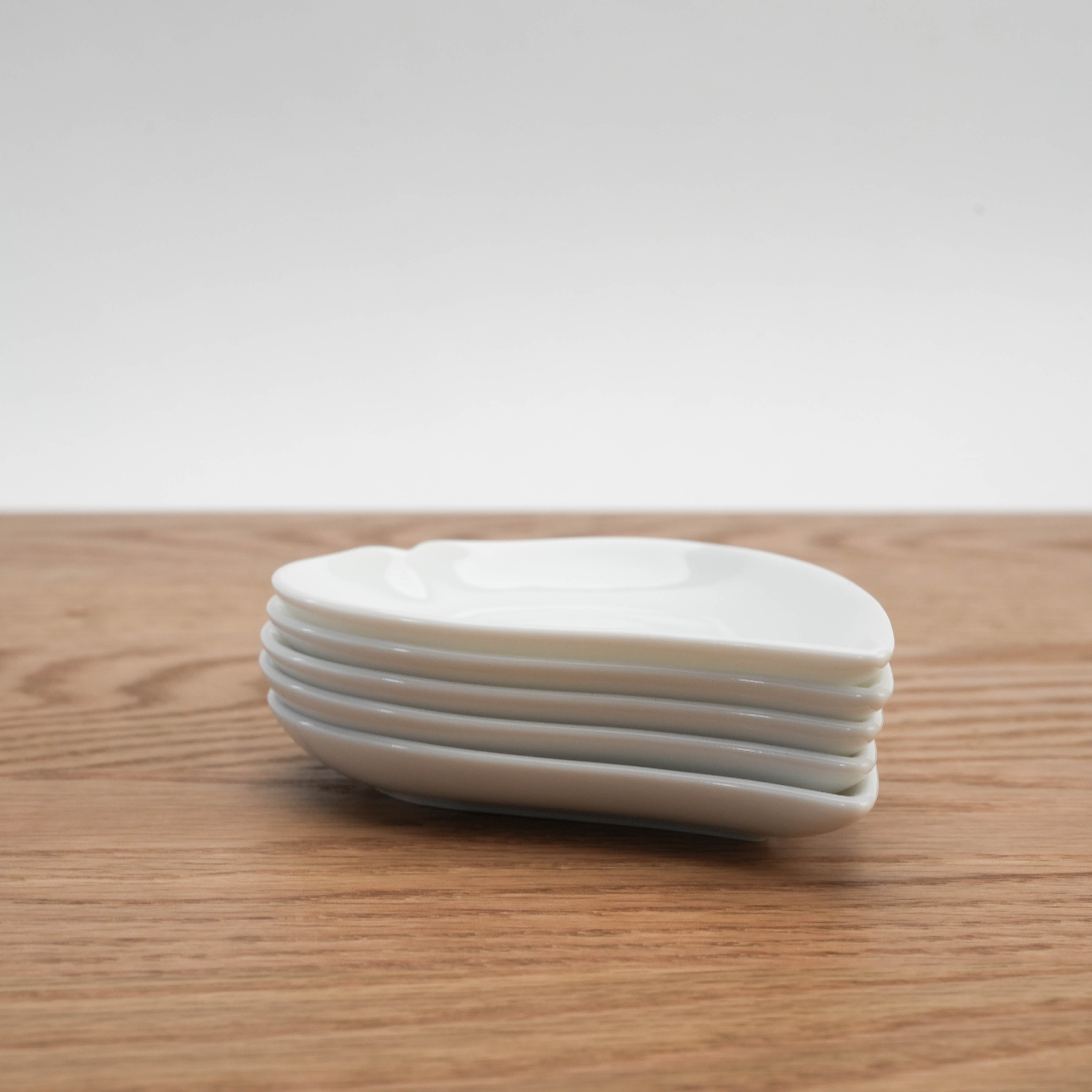 Stacked Mino Ware Sakura Petal Plates in a set of 5, highlighting sleek, space-saving design for modern kitchens.