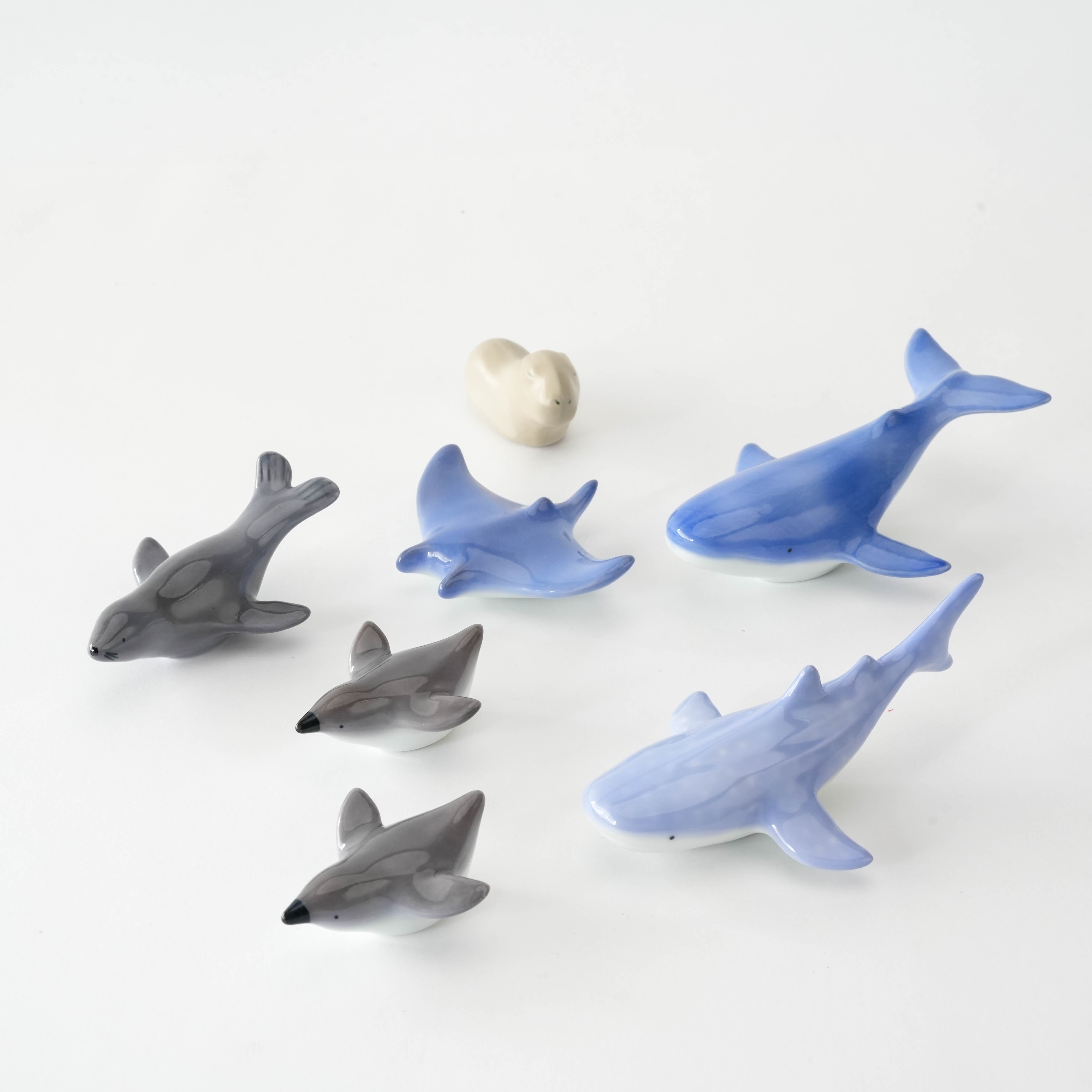 Collection of ocean-themed Arita porcelain chopstick rests including manta ray, whales, and dolphins, perfect for marine-inspired dining decor.