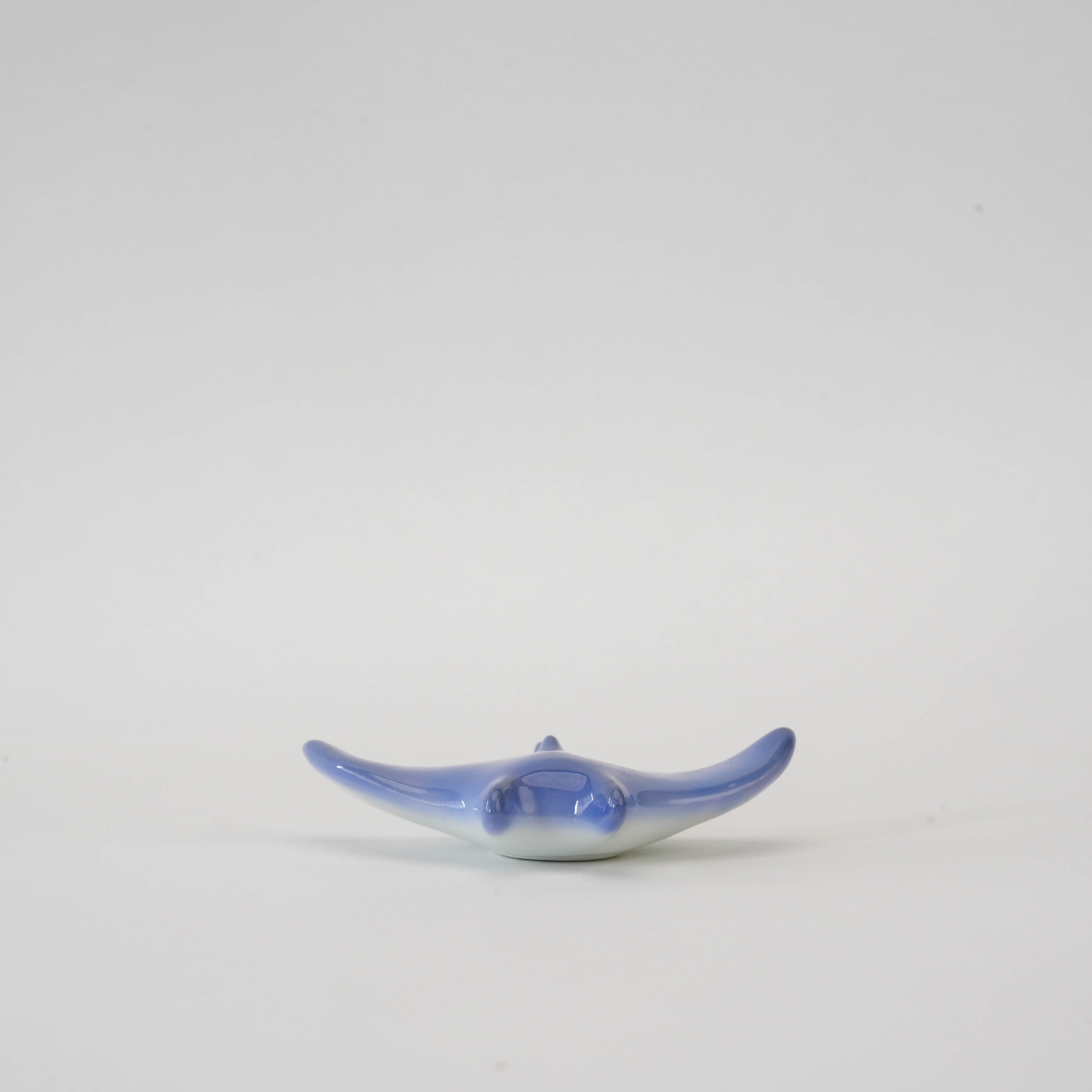 Front view of Manta Ray Chopstick Rest in Arita porcelain, showcasing its smooth ocean blue finish and functional design.