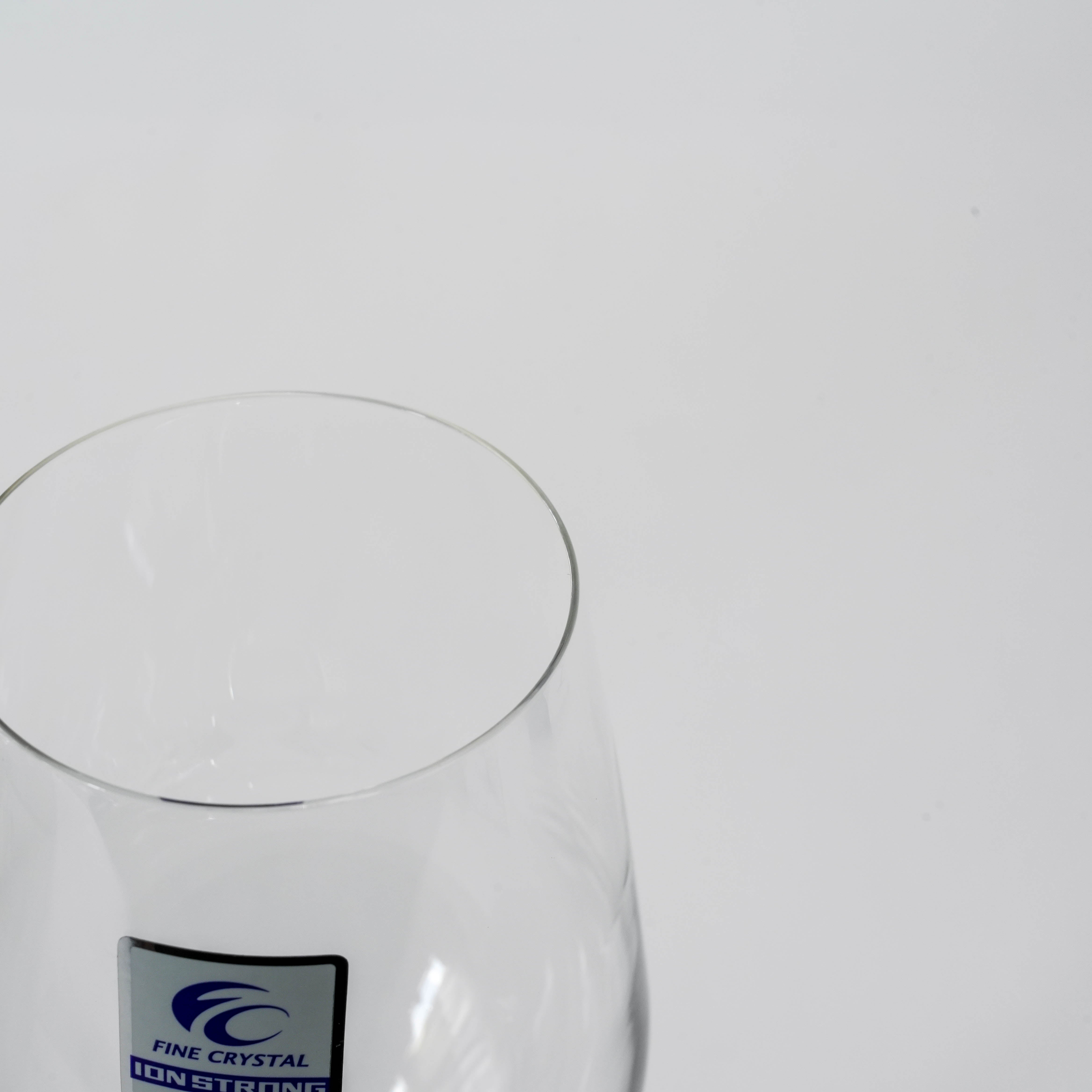 Close-up of Toyo-Sasaki Wine Glass - Fine Crystal | 255ml, showcasing Ion Strong label and ultra-clear crystal craftsmanship.