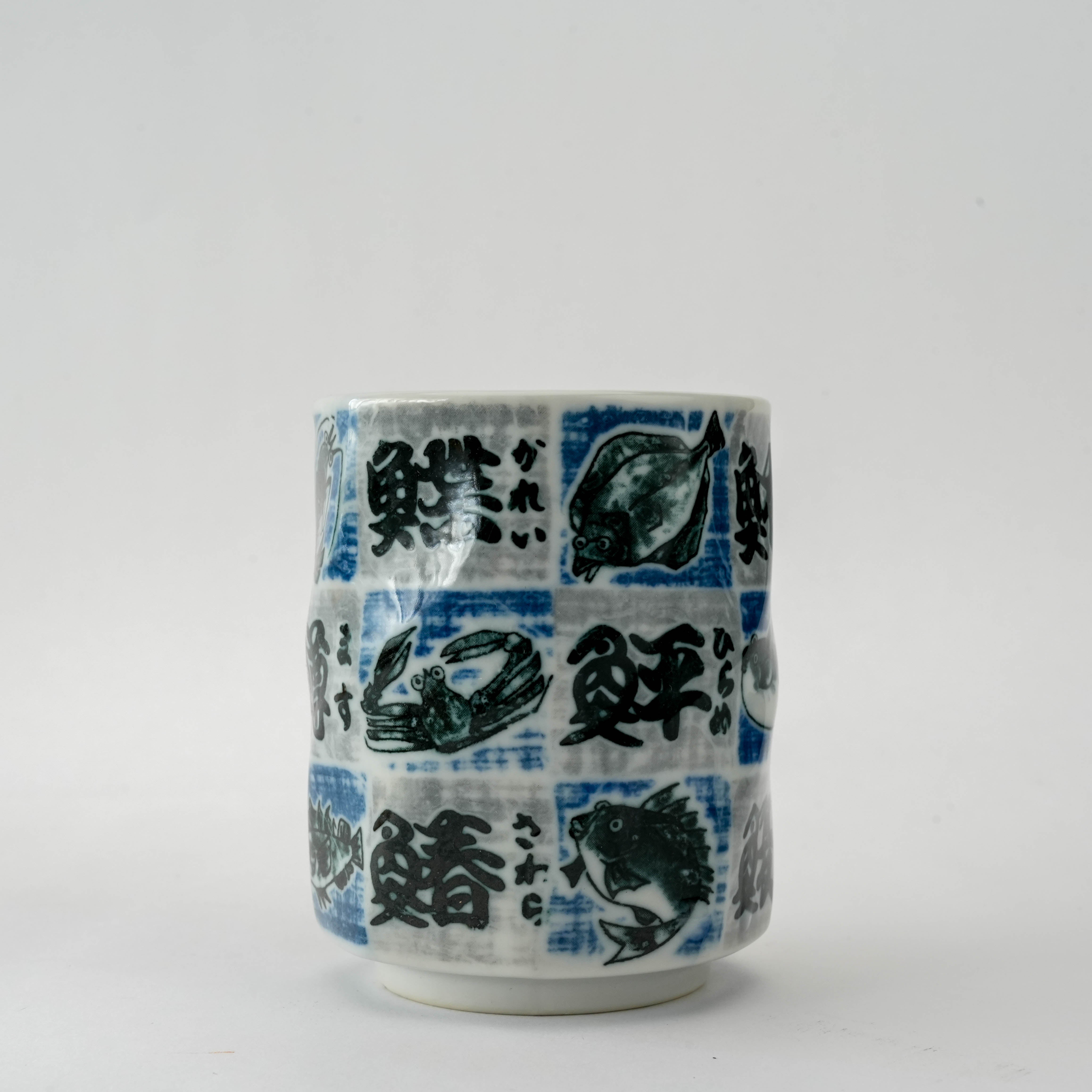 Close-up of Tsubame Fish Tea Cup highlighting intricate fish motif and twisted checkerboard design, blending Japanese art with functionality.