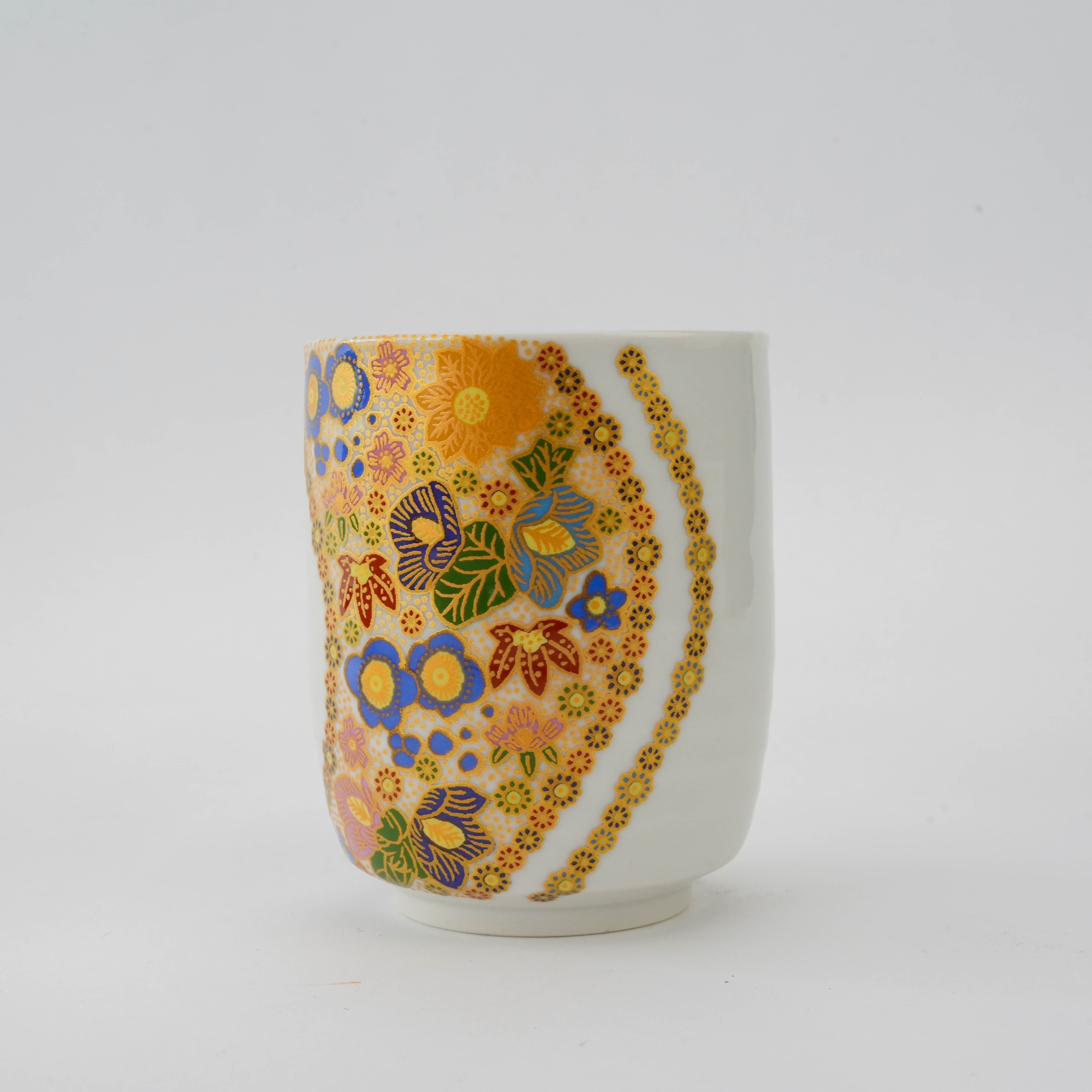 Kutani Ware tea cup from the Mutsugoromo Flower Dinner Set, showcasing colorful floral motifs and gold embellishments in traditional Hanazume style.