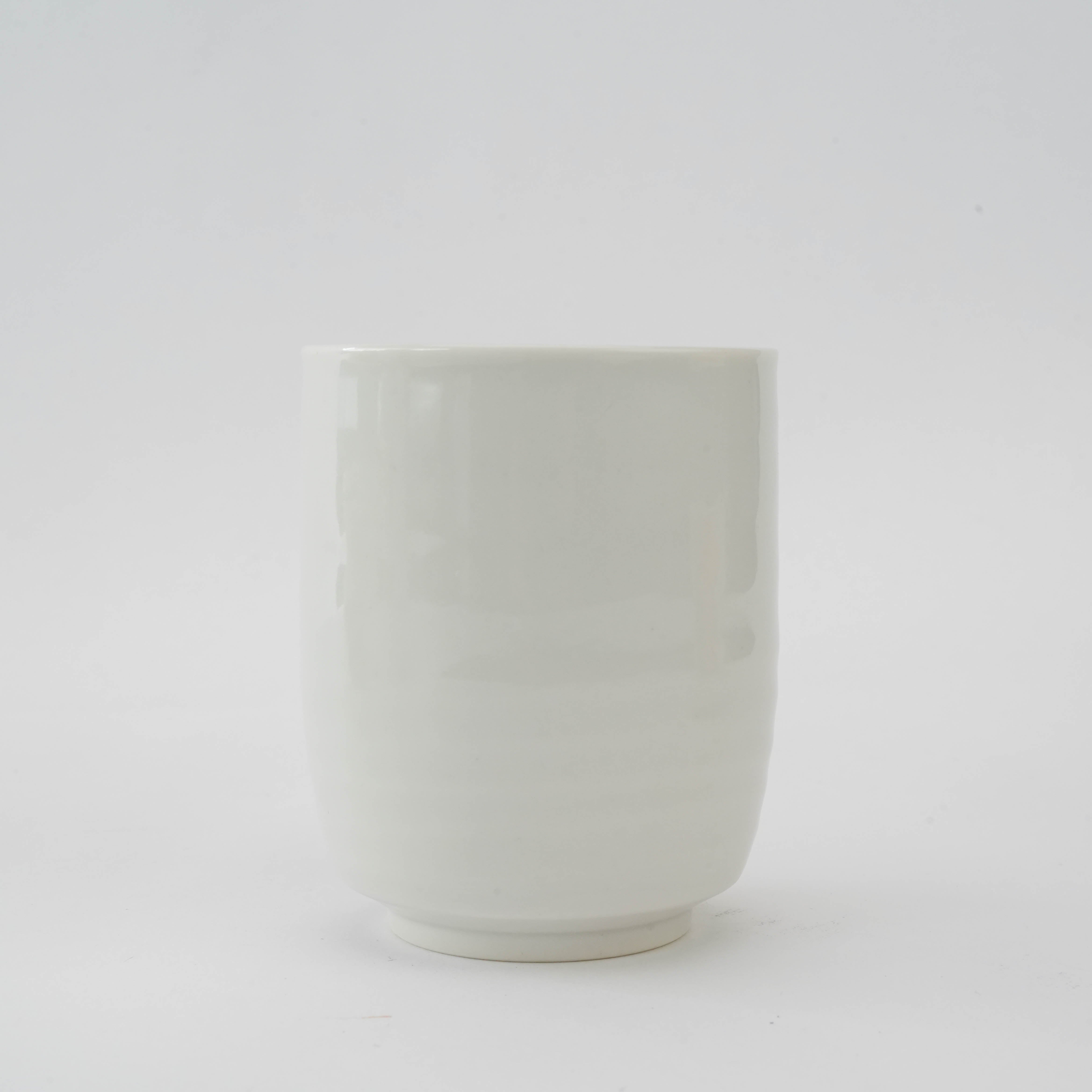Back view of a Kutani Ware tea cup in the Mutsugoromo Dinner Set, featuring a clean white porcelain finish without decoration.