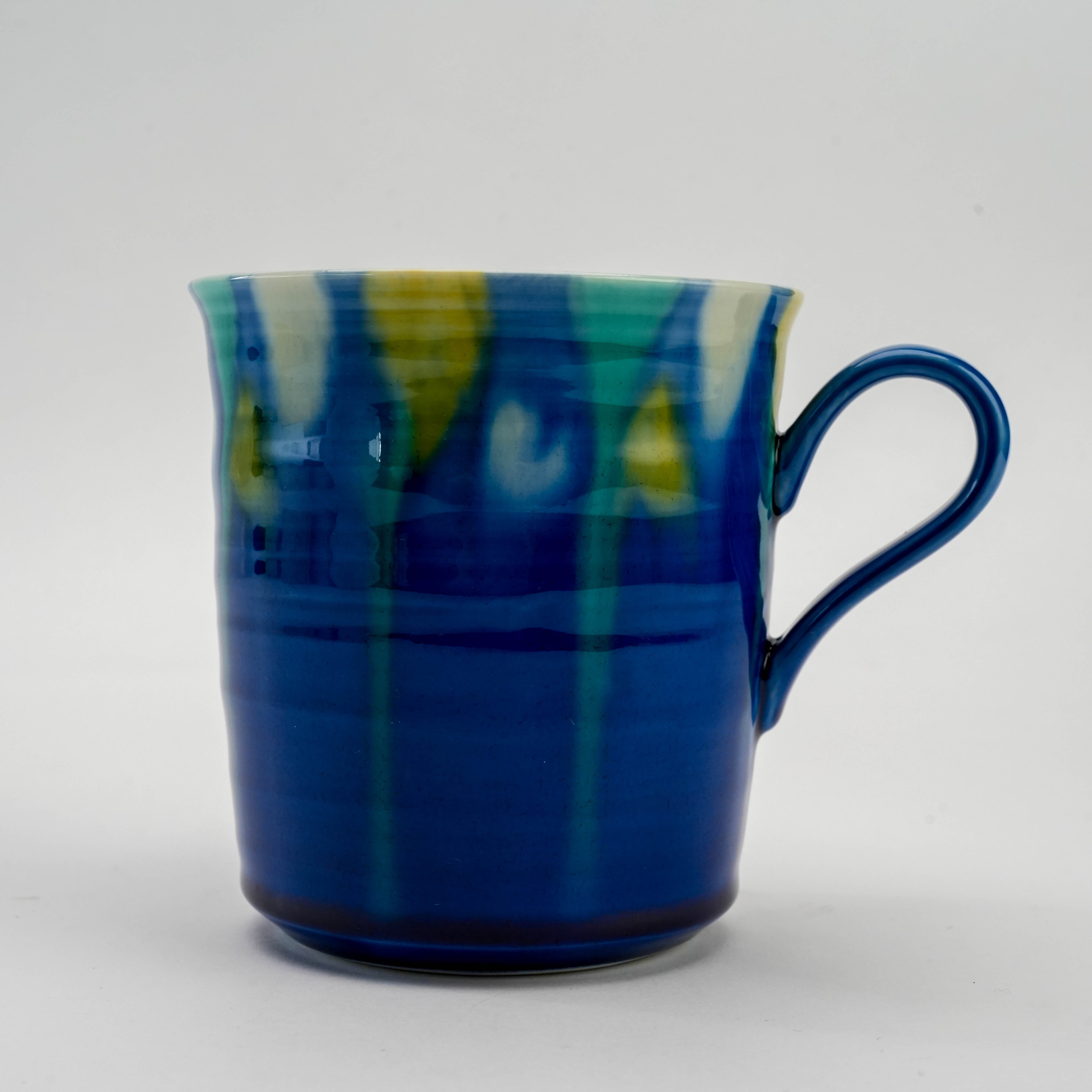 Close-up of Kutani Ware Blue Gradient Mug showcasing vivid cobalt glaze with green and yellow accents, perfect for hot beverages.
