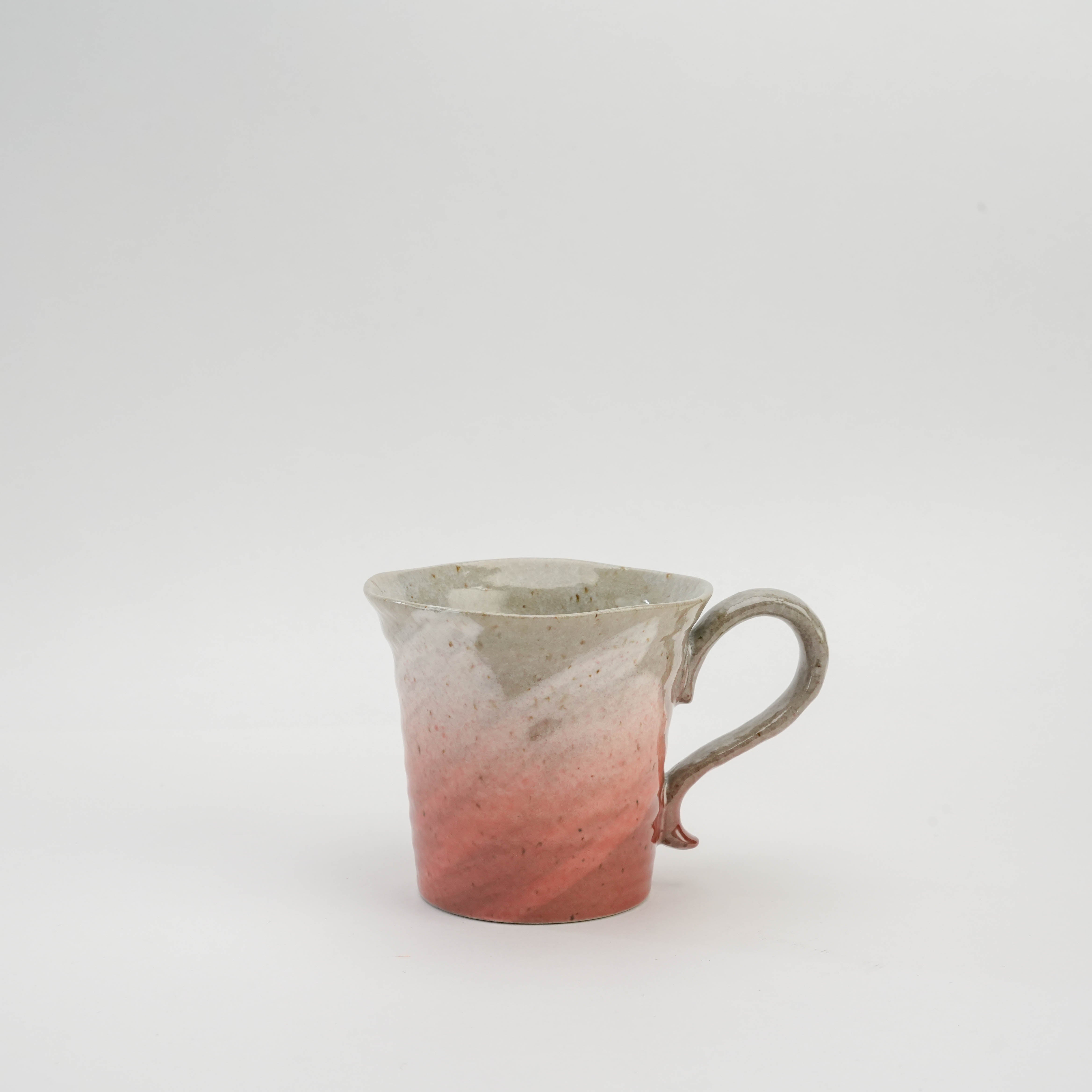 Kutani Ware Sakura Mug in cherry blossom pink glaze with rustic porcelain texture and artisan handle, perfect for tea lovers.